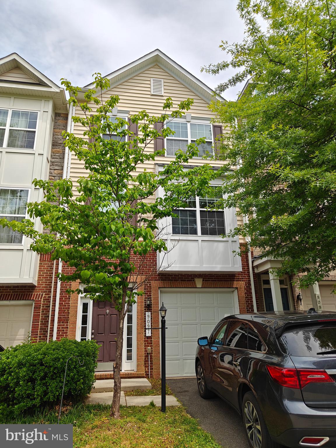 Well maintained and beautiful 3-level garage townhouse offers stunning, luxury living with good sized 3-bedrooms, 3.5-bathrooms. Located in a prime sought-after neighborhood. Starning hardwood flooring throughout the second level and hallways. Designer touches that elevate the aesthetic appeal. The lower level is a versatile space, perfect for a spacious family room or an additional bedroom, complete with a full bathroom and a walkout to a beautifully landscaped back patio. The main level features an open floorplan that seamlessly connects the gourmet kitchen, dining, and living areas. The gourmet kitchen is equipped with large center island, quality cabinets, stainless steel appliances, and luxurious granite countertops. Adjacent to the kitchen is a maintenance-free deck, providing a perfect spot to unwind while overlooking the lush woods. Upstairs, the opulent primary suite awaits, boasting good-sized sitting area, walk-in closet, and an en-suite upgraded bath with large spa-style shower and double vanities. Two additional bedrooms and a full bath, and laundry room complete the upper level. Minutes of walking to the VRE train station, close to shopping stores. You can’t miss it.