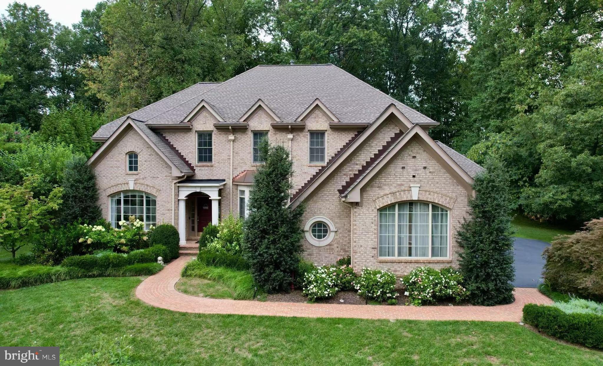 Welcome to Estates at Longwood, a premier "close-in" community in Great Falls, featuring 49 estate homes nestled among towering trees and stunningly landscaped grounds. This meticulously maintained Edgemoore-built all-brick colonial is set on a beautifully landscaped lot, offering approximately 7,500 finished square feet across three bright, airy levels. It includes four bedrooms, five full bathrooms, and one half bath.
Freshly painted and move-in ready, this exquisite home is perfectly situated on a prime lot within this highly desirable community. The thoughtfully designed open floor plan begins with a grand two-story foyer, leading to gleaming hardwood floors, expansive windows, sun-drenched sunrooms, and access to a custom deck and two patios—ideal for entertaining and barbecues. The home also boasts three HVAC zones for year-round comfort, as well as a sprinkler system for easy maintenance.
The upper level features an elegant primary suite with a custom walk-in closet and a luxurious bath with a steam shower and jacuzzi. There are also three additional bedrooms, two full bathrooms, and a convenient laundry room on this level. The finished lower level offers a media room, exercise room, guest bedroom, bonus room, storage areas, wine cellar and two full bathrooms, one of which includes a steam shower.
This home is truly a family dream, providing everything you could desire for comfortable living.
Located in a prime spot, it’s just a minute to Route 7 and Georgetown Pike. You’re minutes from Great Falls Village, walking distance to Forestville Elementary, and only 10 minutes to Dulles International Airport, Tysons Mall, and the metro station. Plus, it’s within the Langley High School district!
