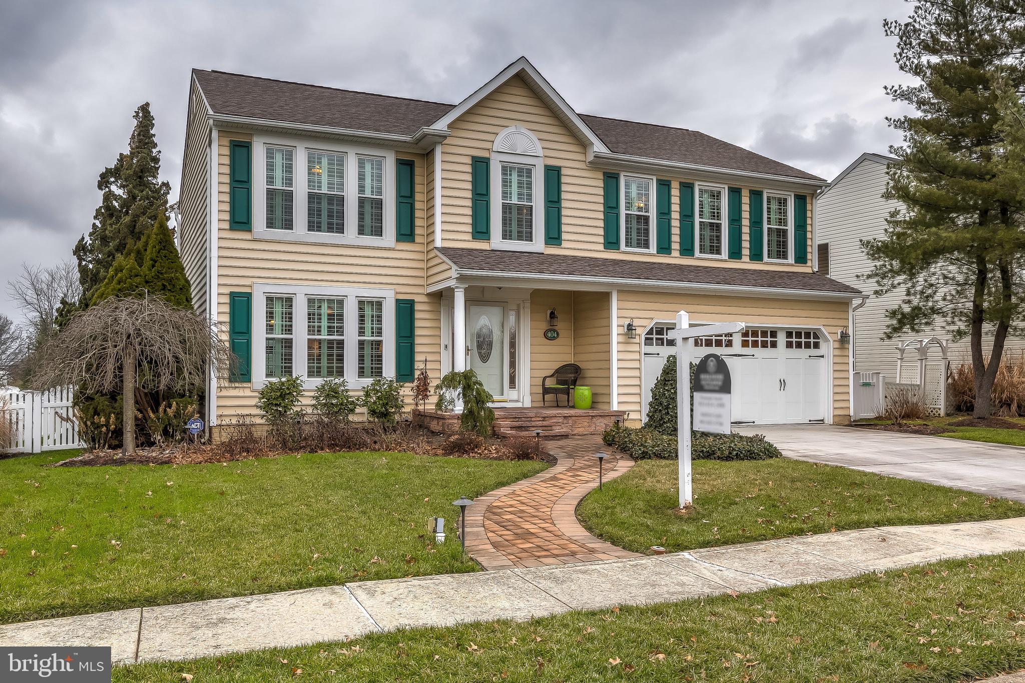STUNNING COLONIAL LOCATED ON QUIET CUL-DE-SAC STREET W/ OVER 3000 SQ FT OF LIVING SPACE - loaded with upgrades and meticulously maintained  this home features an open floor plan with hardwood floors throughout, an abundance of crown molding, wainscoting and shadow box trim with sliding barn door transitions.  The designer chef's island kitchen offers slate tile flooring, granite countertops, under cabinet lighting, tile backsplash, custom cabinetry with wine fridge and convenient built-in breakfast nook with additional storage leading to to expansive rear addition with vaulted ceilings and loads of natural light overlooking fenced rear yard with trex deck and outdoor wood burning fireplace.  Upper level features large bedrooms, oversized laundry room and luxurious owner suite with walk-in closet, huge bathroom covered in carrara marble tile with double bowl vanity, separate tub & shower and heated tile floor.  Not to be missed is the fully finished lower level (optional 4th bedroom) with egress window, large bar area with granite countertops and two car garage.  Original owners have completed many improvements in last 5 years including all new windows, new beaded vinyl siding, new architectural shingle roof, replaced the a/c units, installed water irrigation system and new paver walkways and porch - shows like a model home!