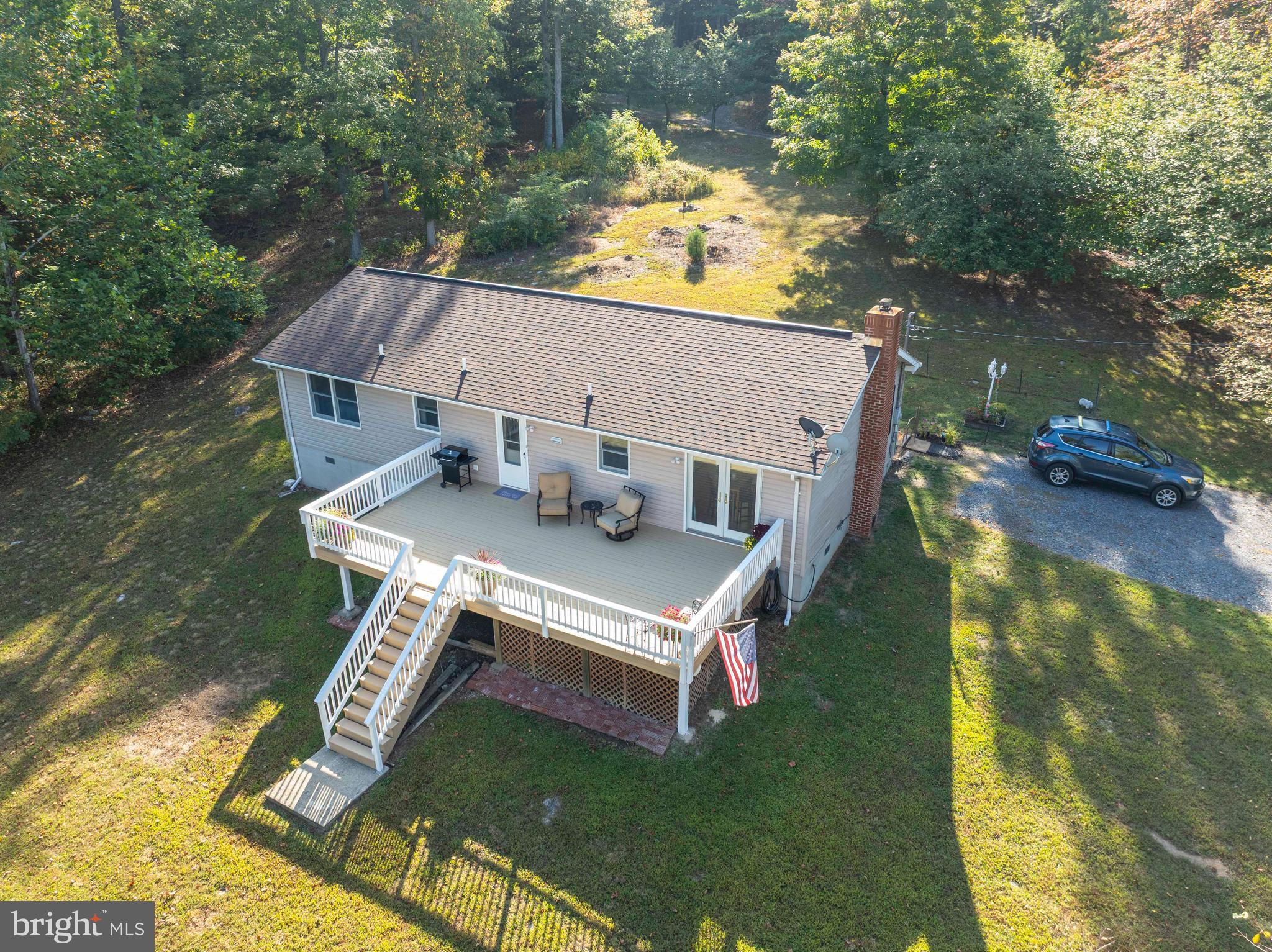 PRICE CORRECTION WITH A $24,000. SAVINGS...Surrounded by nature's glory with convenient access and full of potential, this three bedroom home is set on  40 acres of unrestricted land that features two large detached garages, high speed fiber optic internet, bordered by a natural spring-fed brook and a wet weather stream with several hunting options for game enthusiasts. With fully paved roads set adjacent to Sideling Hill WMA, the property features year-round access and a comfortable home that can be a primary home or secondary retreat.  The home features a full primary bedroom and bathroom suite, a large kitchen with views to the living and dining rooms, plus two guest bedrooms that share a second full bathroom.  There are large windows and skylights for daylighting, a wood burning stove to cut the winter cold, and a large deck and campfire ring for outdoor enjoyment.  With riding trails to access the full extent of the acreage, this property is ready the next adventure.  The larger garage includes a commercial car lift with two oversized garage doors suitable for commercial vehicles or RVs.