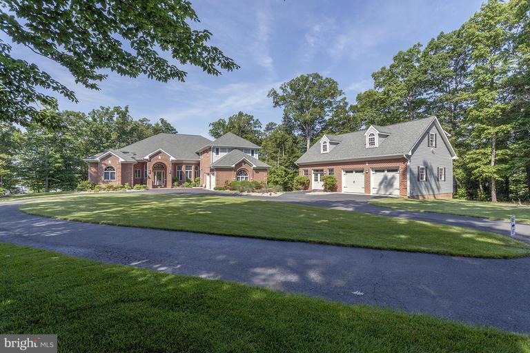 6000 sq ft Custom brick home nestled on private peninsula overlooking Patuxent River. Whether entertaining in gourmet kit overlooking fam rm w/abundant views/windows everywhere or retreating to the lanai in the evening, this home is the dream lifestyle. Det 2 car garage w/loft allows for addl parking, boats, in home business. Every upgrade imaginable incl indoor/outdoor full house surround system.