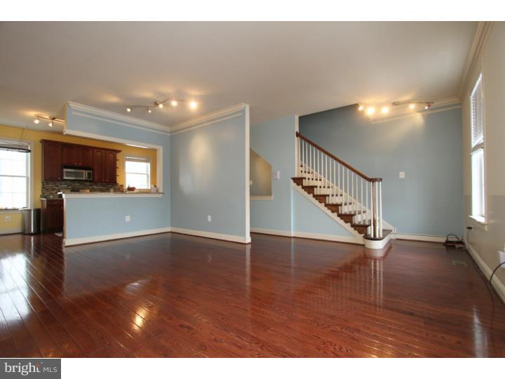 Beautiful 3 bedroom Fishtown brick front with parking, a family room, and 2.5 baths. There are so many beautiful features to enjoy in this home. Enter in to the foyer with garage entrance and large rear family room with glass sliding doors leading to a cute fenced in rear patio, with space for plantings. The 2nd floor features a stunning kitchen with breakfast bar, and a modern open floor plan. 42" solid cherry wood cabinets, granite counters and glass tile back splash, all stainless appliances are included (range, refrigerator, dishwasher, microwave, washer/dryer), a food pantry and the side by side washer and dryer are tucked neatly away in the kitchen for convenience. Beautiful cherry floors in pristine condition on the entire 2nd floor and ample room for a living and dining room.3rd floor has 3 bedrooms a hall bath and the master bedroom includes a private bath with upgraded vanity and accent tile work. The home has central air, gas cooking, plenty of storage throughout.  There is even 4 years remaining on the tax abatement. All the creature comforts conveniently located to everything. We welcome your showings.