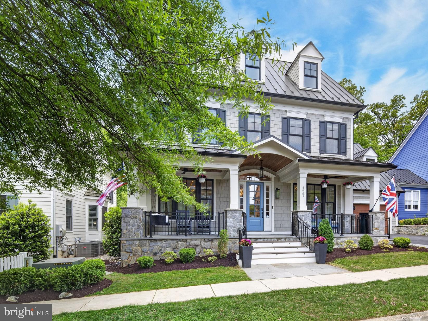 Nestled in the coveted Kentlands community, 127 Thurgood Street presents an extraordinary expression of modern luxury, architectural sophistication, and resort-caliber living in one of the region's most walkable and beloved neighborhood settings. Completed in 2020 by prestigious local builder, Mitchell & Best and encompassing approximately 11,500 square feet, this exceptional residence blends timeless design with the comfort and efficiency of newer construction, and is ideally situated moments from the Kentlands clubhouse, pool, tennis and pickleball courts, basketball court, parks, lakes, playgrounds, walking trails, boutiques, and within walking distance to over 20 restaurants, bars and coffee shops.

A stately stone-front porch with a wood-paneled ceiling sets the tone for the craftsmanship found throughout. Ten-twelve ft ceilings across four finished levels, wide-plank hardwood flooring with built-in radiant heat establish an atmosphere of quiet refinement. The main floor features a dedicated music room with baby grand piano, a private office with custom built-ins, a formal dining room with tray ceiling, built-in cabinetry, and a family room anchored by a 50-inch gas fireplace with integrated surround sound.
At the heart of the home is an exceptional chef's kitchen with dual Cambria quartz islands and an elite suite of professional appliances, including a Wolf range with four gas burners and double-wide griddle, Miele refrigerator, freezer columns, two Cove dishwashers and custom cabinetry. The kitchen opens to an extraordinary four-season room and lounge with dramatic eight-foot recessed sliding glass doors. Radiant heated tile floors, retractable screens and a double-sided 42-inch gas fireplace, transforms this space into a year-round retreat. A mudroom with eight-person cubbies, built-in desk, farm sink and custom built-in closet completes the main level.

The second level is anchored by a primary suite of exceptional elegance. A fireplace, custom built-in bookshelves, and window bench create a sense of sanctuary, while a private sitting room with wet bar and wine refrigerator adds another layer of luxury. The spa-inspired primary bath features heated floors, a freestanding soaking tub with waterfall spout, a smart steam shower with aromatherapy, and a recessed waterfall shower. Dual custom walk-in closets and access to a private deck complete the suite. Four additional bedrooms, including 3 en-suites and a Jack-and-Jill suite with six-foot soaking tub and heated towel rack, plus a dedicated laundry room, offer beautifully finished accommodations.
The top floor adds two additional bedrooms, a full bath, and a yoga studio featuring its own secret bookshelf door. An elevator and thoughtfully integrated hidden passages throughout the home add a distinctive layer of charm.

The lower level is a destination unto itself complete with bar area and an inviting recreation room featuring a 50-inch gas fireplace, pool table, and 10-foot shuffleboard table complete the entertainment experience.  Enter the barrel-vaulted, wood-lined wine café into a custom wine cellar. Guests may want to stay in the hidden bedroom on this floor. Most extraordinary is the private indoor aquatic center featuring a built-in endless pool with dual resistance jets, heated tile floors, and custom Alex Turco wall murals. A fully equipped gym, five-person infrared sauna, and six-person Marquis hot tub complete this wellness retreat.
Outdoor living is equally well conceived, with a main-level deck featuring a built-in gas grill, pizza oven, and refrigerator. Two EV chargers, an in-ground smart sprinkler system, and whole-home and exterior sprinkler systems reflect the home's thoughtful integration of modern technology.
127 Thurgood Street is a truly rare offering: a move-in-ready estate of exceptional scale, craftsmanship, and amenity, set within one of the area's most admired communities.