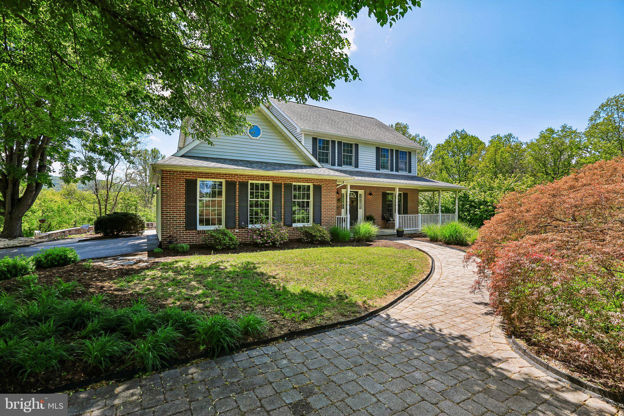 Set against a backdrop of open skies and rolling views, this custom-built Colonial on over 2.5 private acres offers a rare blend of refined living and everyday tranquility. From the moment you arrive, the setting invites you to slow down—whether enjoying quiet mornings on the front porch or unwinding as the sun sets across the landscape.


Inside, nearly 2,400 square feet of thoughtfully designed space balances timeless architecture with modern updates. The main level unfolds with ease, featuring a sunlit breakfast area, an elegant dining room for gatherings, and a warm, inviting family room anchored just off the kitchen. Recently updated appliances, abundant cabinetry, and seamless flow make the kitchen both functional and stylish.


Throughout the home, all bathrooms have been tastefully enhanced, offering a fresh, sophisticated feel. A whole-house GENERATOR ensures comfort and confidence in every season.


The fully finished walkout lower level expands the home’s versatility, offering a large amount of finished flex space ideal for a home office, gym, media room, or guest retreat. A dedicated workshop area, abundant storage, and a cozy propane stove complete this level, adding both function and character.


Designed with both lifestyle and practicality in mind, the property includes an attached garage along with a separate 2-car DETACHED garage—perfect for collectors, hobbyists, or those who simply value space to spread out.


Adding to the sense of PRIVACY and connection to nature, the property is directly adjacent to approximately 26.66 acres of open space and forest retention. A nearby trail leads toward Israel Creek, creating the perfect setting for peaceful walks, exploring, and enjoying the natural beauty that surrounds the home.


With recent updates including new flooring and carpet, this home is truly move-in ready. Ideally located just minutes from Rt. 340, it offers the perfect balance of peaceful seclusion and everyday convenience.


A place to gather, to relax, and to enjoy the beauty of your surroundings—this is more than a home, it’s a lifestyle.
