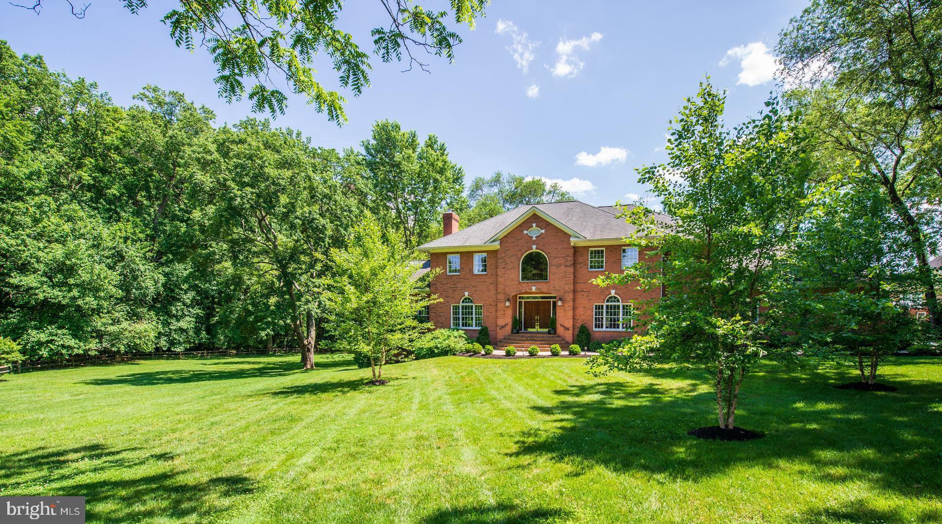 Stately Colonial on 1.8 acres with lush lawns, Deck, Playhouse, gorgeous Pool and 3-car Garage with high ceilings. The Main Level features high ceilings, wood floors, two-story Foyer with marble floors, formal Living Room and Dining Room, Sun Room, Library with built-ins and Laundry Room. The Chef s Kitchen is adorned with top-of-the-line appliances, large center Island with Gas Cooktop and Custom Cabinets. Breakfast Room has Bay Window and opens to Family Room. The Family Room with access to the Deck features a Marble Fireplace, Wet Bar with Beverage Refrigerator and Wine Cooler. Spacious Master Retreat has Sitting Room and spa-like Bath. The Upper Level also includes three additional Bedrooms and two Bathrooms. Walk-out Lower Level boasts Recreation Room with brick Fireplace, Beverage Center/ Wet Bar, two private Bedrooms and Full Bath. Approximately 6000 Sq. Ft. Great commuting location with multiple routes to DC Metro area and Dulles Airport.