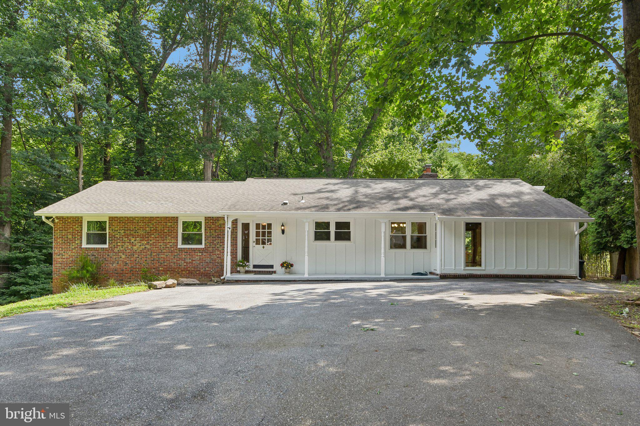Welcome to 10206 Green Clover Court, Ellicott City, MD 21042. Nestled at the end of a quiet cul-de-sac in the highly desirable Allenford community, this exceptional rancher offers the perfect blend of private, serene living and urban convenience. Boasting excellent Ho Co schools and no HOA, this home features 4 spacious bedrooms and 4 full baths, with a design built for effortless living. Step into the welcoming front foyer. To your left, the main sleeping quarters feature a primary suite with double closets and a private en-suite bath, alongside two additional bright bedrooms—all upgraded with newly installed ceiling fan and light fixtures—and a second full bath. To the right, the home opens up to a gourmet kitchen equipped with granite countertops, new appliances-  cooktop, double wall oven, and refrigerator. The seamless flow leads into the dining area and a spacious living room centered around a cozy wood-burning fireplace, illuminated by elegant recessed lighting. Nearby, a versatile fourth bedroom offers its own en-suite bath, deck access, and a private entrance from the driveway—ideal for guests or an in-law suite. The expansive lower level adds incredible living space, featuring a massive recreation room with recessed lighting, a full bath, and a seamless walkout to the patio and a huge deck. You will also find a large storage area and two bonus rooms perfectly suited for a 5th bedroom, home office, or den. Outside, the property acts as a private oasis, backing directly to the beautiful woods of Patapsco State Park. Complete with an expansive driveway and parking pad that comfortably accommodates multiple vehicles right at your front door, this turnkey home is a absolute must-see!