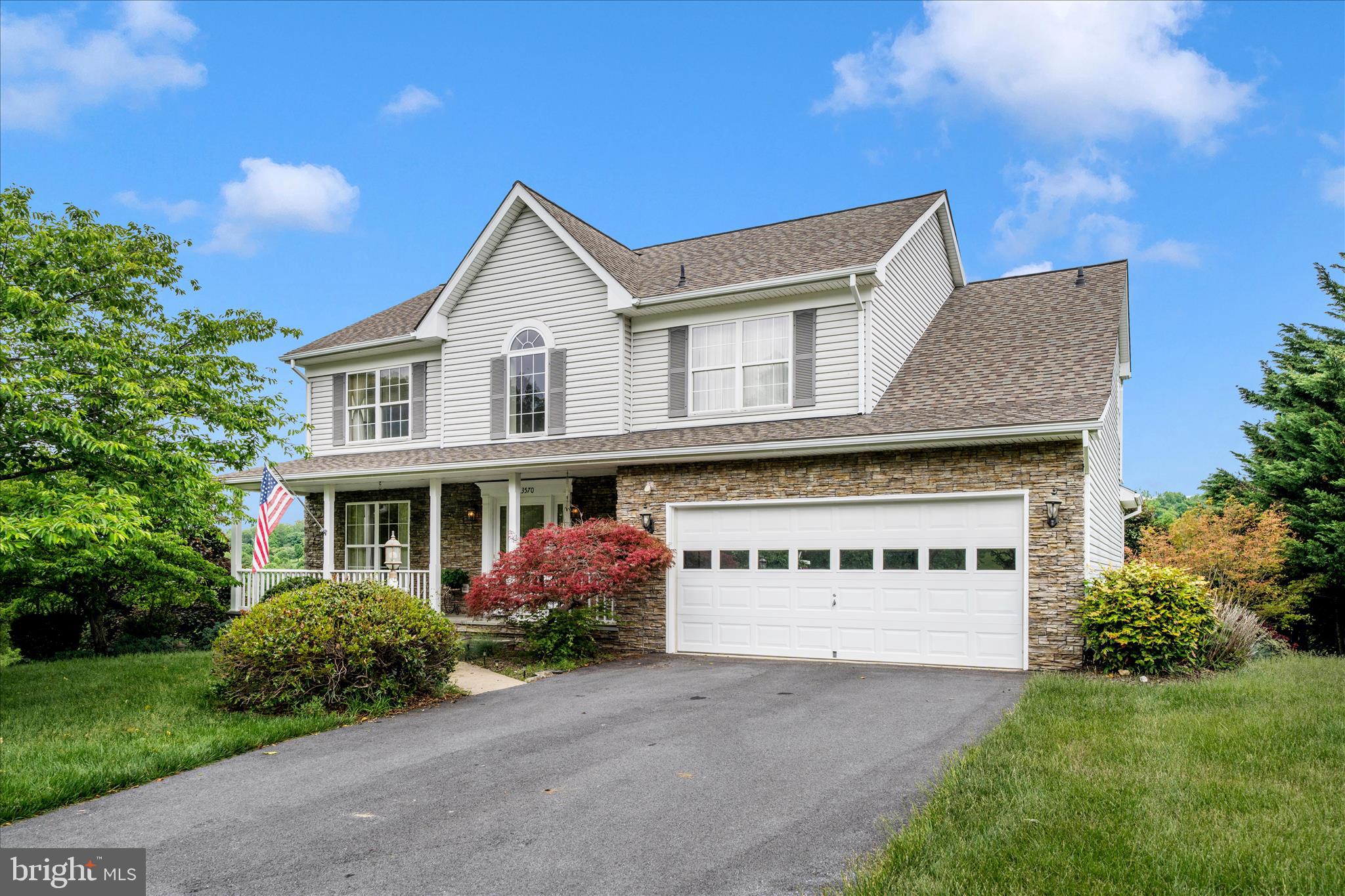 **Open House Cancelled!** Property is under contract.
Welcome to 13570 Deer Brook Court in Mount Airy, MD — a beautifully maintained home situated on a gorgeous lot and accented with elegant stone details that create exceptional curb appeal.
Step inside to a dramatic two-story foyer highlighted by a stunning curved staircase, offering a warm and impressive welcome for guests. The expansive kitchen is designed for both everyday living and entertaining, featuring abundant white cabinetry, a large center island, gas cooking, pantry storage, and stylish pendant and recessed lighting. Just off the kitchen, the spacious family room flows seamlessly into the adjoining sunroom, where a wall of windows fills the space with natural light.
Upstairs, the inviting primary suite showcases a cathedral ceiling, a charming built-in bench with a hidden laundry chute, and a large walk-in closet complete with an organization system. The en-suite bath is impeccably maintained and includes dual vanities, a corner soaking tub, and a walk-in shower. Two additional generously sized bedrooms and a conveniently located upper-level laundry room complete this floor.
The finished lower level offers high ceilings, a versatile craft room/home office or potential fourth bedroom, and a spacious recreation area featuring built-in office cabinetry and a striking stone accent wall. Step outside to the hardscaped patio with awning — an ideal space for relaxing or entertaining. An additional unfinished storage area includes a second laundry area and ample room for storage needs.
Adding even more value, all major systems and big-ticket items are less than four years old. This exceptional home combines comfort, style, and functionality in a sought-after location. Schedule your private showing today.