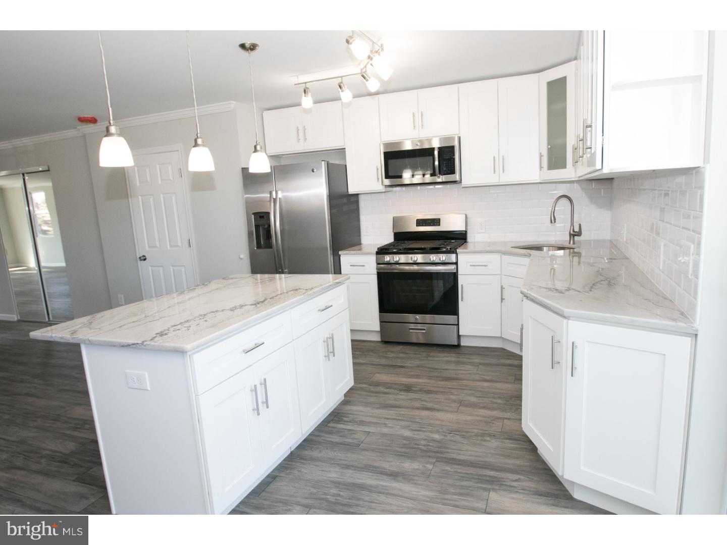Unbelievable newly renovated twin home, very conveniently located opn a great street in East Mt. Airy! The entire home has been newly rehabbed top to bottom. Do you like elegance? Well this home is one of a kind and offers every extra a buyer could desire. All of the windows have been replaced, and there is a new roof w/ warranty, all new siding, updated electrical & plumbing, and not to mention new energy efficient Heating & AC Units! The 1st floor features a huge open layout with hardwood floors, recessed lighting, a new kitchen, which features stone counter tops and stainless steel appliances. The kitchen also features a sizable central island which is fantastic for entertaining. The upstairs features four sizable bedrooms, two full bathrooms, including an en suite in the master. There are two additional half baths. The lower floor features significant additional livable space and there is a deck off of the kitchen as well. The home features over 3,000 square feet of livable space when the lower level is included.  This home truly has it ALL and is a MUST SEE!
