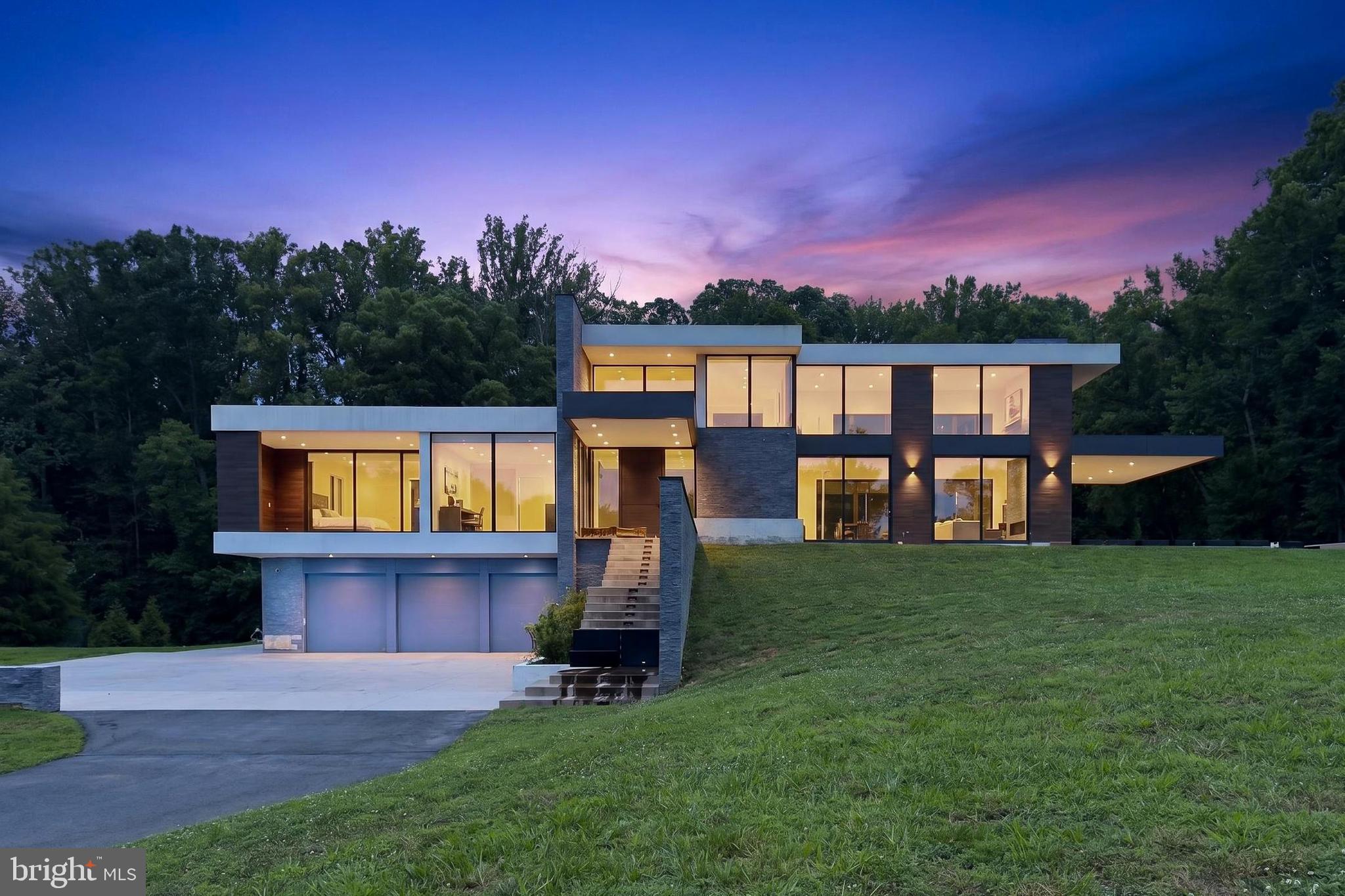 Experience the exceptional potential of this stunning new contemporary home, ideally situated on a beautiful 2-acre lot in sought-after Great Falls. Partially finished and awaiting your personal touches, this remarkable property presents a rare opportunity to customize a luxury residence to your own style and preferences.

Designed with an open, light-filled floor plan, the home offers seamless flow throughout its spacious interior. The main level features a luxurious primary suite, while the home includes a total of four bedrooms and four full baths plus a powder room. The impressive gourmet kitchen is designed to be the heart of the home, featuring two oversized islands, two sink areas, two floor-to-ceiling refrigerators, a gas cooktop, and abundant workspace for entertaining and everyday living.

Beautiful stone and tile finishes enhance the home's contemporary design, while two fireplaces and spa-inspired bathrooms add warmth and sophistication. Outdoor living spaces include a large covered deck off the kitchen and a covered patio adjacent to the family room, all overlooking the picturesque property. A three-car garage provides ample parking and storage.

This is an incredible opportunity to complete a spectacular custom home in one of Northern Virginia's most desirable locations.

PLEASE USE EXTREME CAUTION WHILE TOURING THE PROPERTY. The home has many unfinished areas throughout. Enter the covered patio and deck off Family Room at your own risk, there are no rails and very steep drops.  Exercise care when viewing unfinished areas inside. In particular, watch your step around the stairs where some of the unfinished area is uneven.