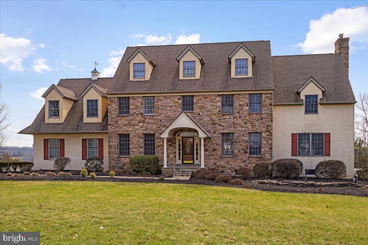 Searching for a multi-generational home? Nestled on a quiet cul-de-sac within the serene landscape of Tinicum Township, this exquisite 4-5 bedroom stone front colonial embodies the quintessence of luxury and tranquility. Set on 3.5 manicured acres, the property boasts pastoral and sunset views that are nothing short of breathtaking, best enjoyed from the expansive deck that gracefully runs the length of the house.
As you approach, custom curved stone driveway columns herald the elegance that awaits, leading to a welcoming blue stone front porch, complemented by formal landscaping that exudes a sense of sophistication and charm. The entrance welcomes you into a world where every detail has been carefully curated to offer unparalleled comfort and style. A spacious living room is on the left, and a substantial dining room on the right.
The heart of this home is its open concept kitchen, adorned with cherry cabinets and walls of windows offering lovely views that bring the outside in. The seamless flow from the kitchen dining area through glass doors leads to the deck, providing an idyllic setting for alfresco dining or simply soaking in the vistas. Adjacent to the kitchen, the great room, anchored by a stone wood-burning fireplace, creates an inviting atmosphere for relaxation and entertainment. To the right of the great room is a large private light filled office. This level is completed by a spacious powder room and a mud room leading to the 3 bay garage .
Privacy and luxury define the large primary suite, featuring a spacious bath and a generous walk-in closet, ensuring a peaceful retreat for the homeowners. The house also boasts several office areas, thoughtfully designed to cater to the needs of remote work or study, each offering a unique perspective of the property's natural beauty.
The full finished basement is a testament to functional elegance, encompassing a family room,  music room with acoustic ceiling tiles, fitness room, powder room, laundry area, and a walkout to a spacious patio, ensuring entertainment and leisure options for all ages. Natural light floods the space, highlighting the thoughtful design that makes every area of this home feel welcoming and bright.
Located in the highly desirable Tinicum Township, the property promises a lifestyle of peace and quiet, with the convenience of being just minutes away from Frenchtown, NJ, Lumberville, Doylestown, and New Hope. Each of these nearby locales offers its own unique attractions and amenities, enhancing the living experience for the residents of this magnificent home.
This property is not just a house; it's a sanctuary, where every moment is an opportunity to live life to its fullest amidst a backdrop of unparalleled natural beauty and luxury.