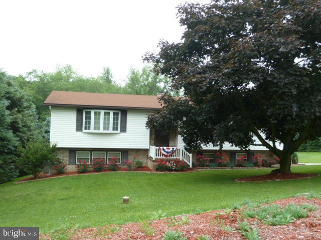 The massive evergreens surrounding this home will take your breath away. Privacy to the max! Inside you'll find beautiful hardwood floors throughout the home. The oak kitchen, with granite counters, touch faucet, and access to sunroom overlooking  the backyard is especially nice. Lower level is finished with a family rm, lau, screened-in patio and service garage.