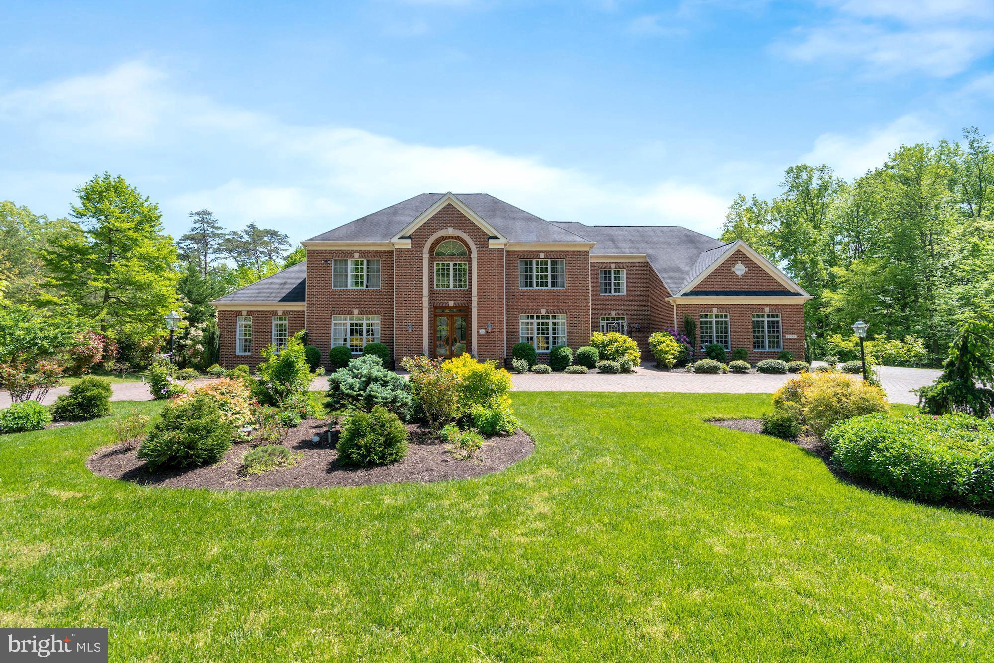 Welcome home to 11408 Wolfs Landing, located in Fairfax County's sought after Fairfax Station located about 22 miles southwest of Washington DC.  This part of Fairfax Station is a haven among rolling hills and tranquil wooded scenic Vistas.    11408 Wolfs Landing is EXCEPTIONALLY well-priced home.  Stately brick custom colonial nestled on beautiful 5 acres, with over 10,000 sq. ft. of living space, 4 CAR SIDE LOAD GARAGE, 6 bedrooms, 5 full baths, 2 half baths, 3 fire-places, 2 laundry rooms and much more. Main level offers 2 story grand foyer, inviting formal living room with fire place, formal dining room, 2 story great room with fire place and floor to ceiling windows bringing the outside in, a large conservatory with high ceilings, a bed room, large gourmet kitchen with enormous counter space and abundance of cherry cabinets, separate eat-in area and a sitting room, 2nd entrance and mudroom area, 2 half baths. Upper level hosts a large primary suite with its own foyer, sitting area, 2 custom- built closets, a large luxury bath with 2 separate vanities, a large soaking tub, a steam shower and a private water closet. 3 ensuites with updated private baths and custom closets and a bedroom level laundry room. Enormous Lower level is perfect for entertaining.  Private Guest Suite with large closet and attached full bath and a separate laundry room. Very open recreation room is great for entertaining. Enough space for pool table, air hockey, foosball table, ping-pong or games of your choice or just relax by the fire place. Beautiful upgraded custom wet bar, luxurious home theater to enjoy movies or games. Separate sitting room with walk-out patio. Well thought out outdoors to enjoy nature at its best. Many fruit trees - 2 sour cherry, 4 persimmons, 2 peach, 2 apple, 2 Cherry, 1 pear- planted around the property. A large composite deck with built-in propane gas grill and a separate charcoal grill - perfect for summer outdoor family time and entertaining. Many updates done by current owners throughout years of their ownership. Enormous paver’s circular driveway was added. 22 KW Generator added in  2013-2014, New Hot Water Heater 2019, HVAC for upper level replaced   6 years ago, lower level Furnace replaced  6 years ago., bedroom level carpet replaced 2017. Looking for open spaces throughout the house, large rooms, need more home office space…..This is a home that will give everyone their own space while working or schooling at home. Simply it's a Gorgeous Home! It's your chance to enjoy this home with your family and friends. All CDC GUIDELINES to be followed during touring the house. Please everyone visiting the house wear MASK, Remove Shoes or wear Shoe Covers, Use Hand Sanitizer and wear Gloves provided in the foyer.  Shown by appointment only.
