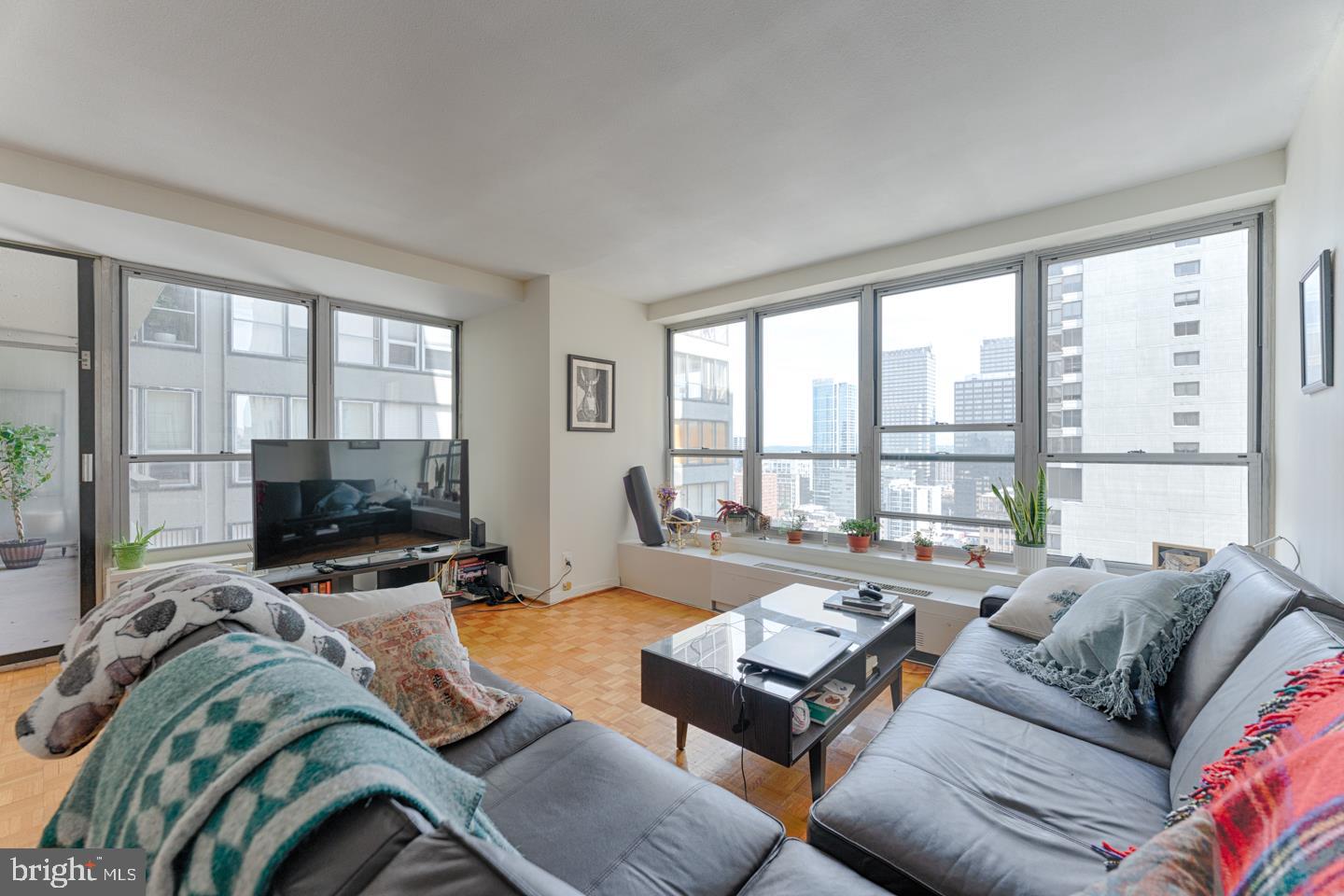 Sun-drenched two bedroom, two bathroom with large private terrace on a high floor of The Dorchester! Enter the residence through a foyer into the sun-soaked great room with walls of windows and open living and dining areas. The great room provides access to a spacious private terrace offering northern city views.  There is a renovated kitchen showcasing updated cabinetry and countertops, tile backsplash and stainless steel appliances. The primary bedroom enjoys a walk-in closet and ensuite bathroom with a glass enclosed stall shower. The second bedroom has a large wall closet and enjoys use of a full hall bathroom. Both baths offer modern vanities and neutral tilework. Additional home highlights include incredible natural light, new windows and great storage space. Residents of The Dorchester enjoy a twenty-four-hour doorman and all utilities included in rent except cable TV. Use of the building's state-of-the-art fitness center, seasonal rooftop pool club, and valet parking in the building's underground garage are available for an additional fee, subject to availability. No pets permitted. Rittenhouse Square is ranked the 6th best neighborhood in North America with 175 restaurants and 199 retailers within a three block radius. The Dorchester is within walking distance to the Market Street office corridor, The Avenue of the Arts and University City. 30th Street Station and Philadelphia International Airport are a short commute.