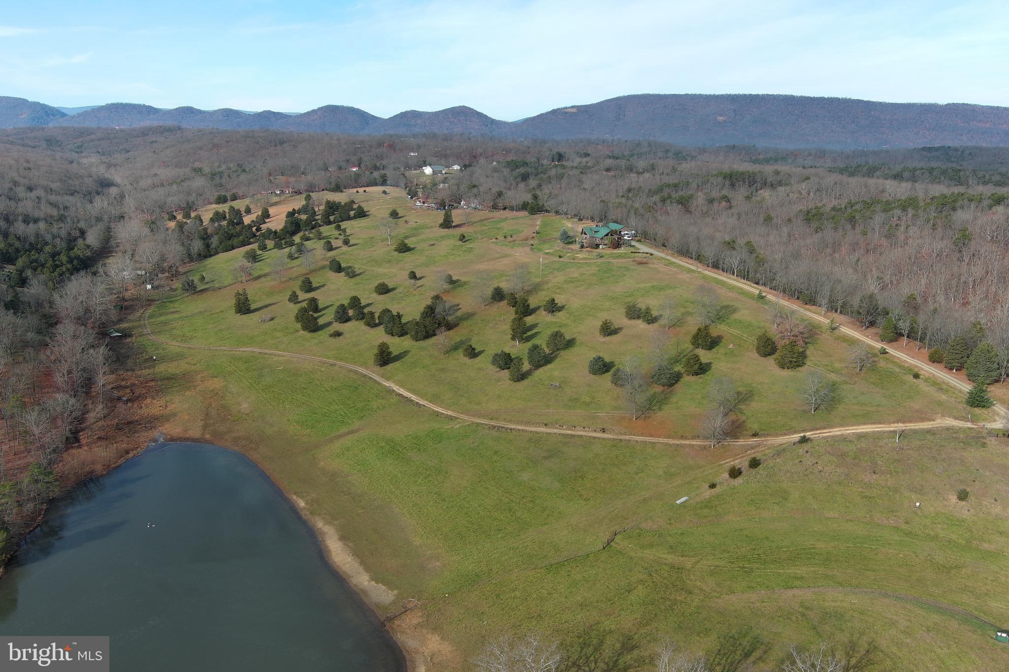 LOOKING FOR THAT EXCEPTIONAL ESTATE WITH A BIT OF EVERYTHING -- LOG HOME ON 39.84 UNRESTRICTED ACRES  WITH BEAUTIFUL VIEWS OF THE MOUNTAINS, VALLEY, AND LAKE.  SEVERAL FENCED PASTURES FOR YOUR HORSES/CATTLE/GOATS/LAMAS.  NUMEROUS OUTBUILDINGS/SHEDS/BARN,  LARGE DOUBLE GARAGE WITH ATTACHED WORKSHOP. 
 RIDING/ATV TRAILS IN PLACE.  FISHING/SWIMMING IN THE LAKE.  HOME IS SITUATED ON A KNOLL WITH LONG RANGE  VIEWS IN THE FRONT AND WOODED PRIVACY TO THE REAR, THIS MAGNIFICENT LOG HOME IS BUILT WITH 12" HAND HEWN MAINE LOGS, LIFETIME GUARANTEED GALVALUME ROOF AND EXPANSIVE DECKS.  PLUS 775' OF LAKEFRONT ON A 6 1/2 ACRE PRIVATE LAKE,  INTERIOR IS WOOD, WOOD, AND MORE WOOD.  THIS IS ONE YOU DON'T WANT TO MISS.