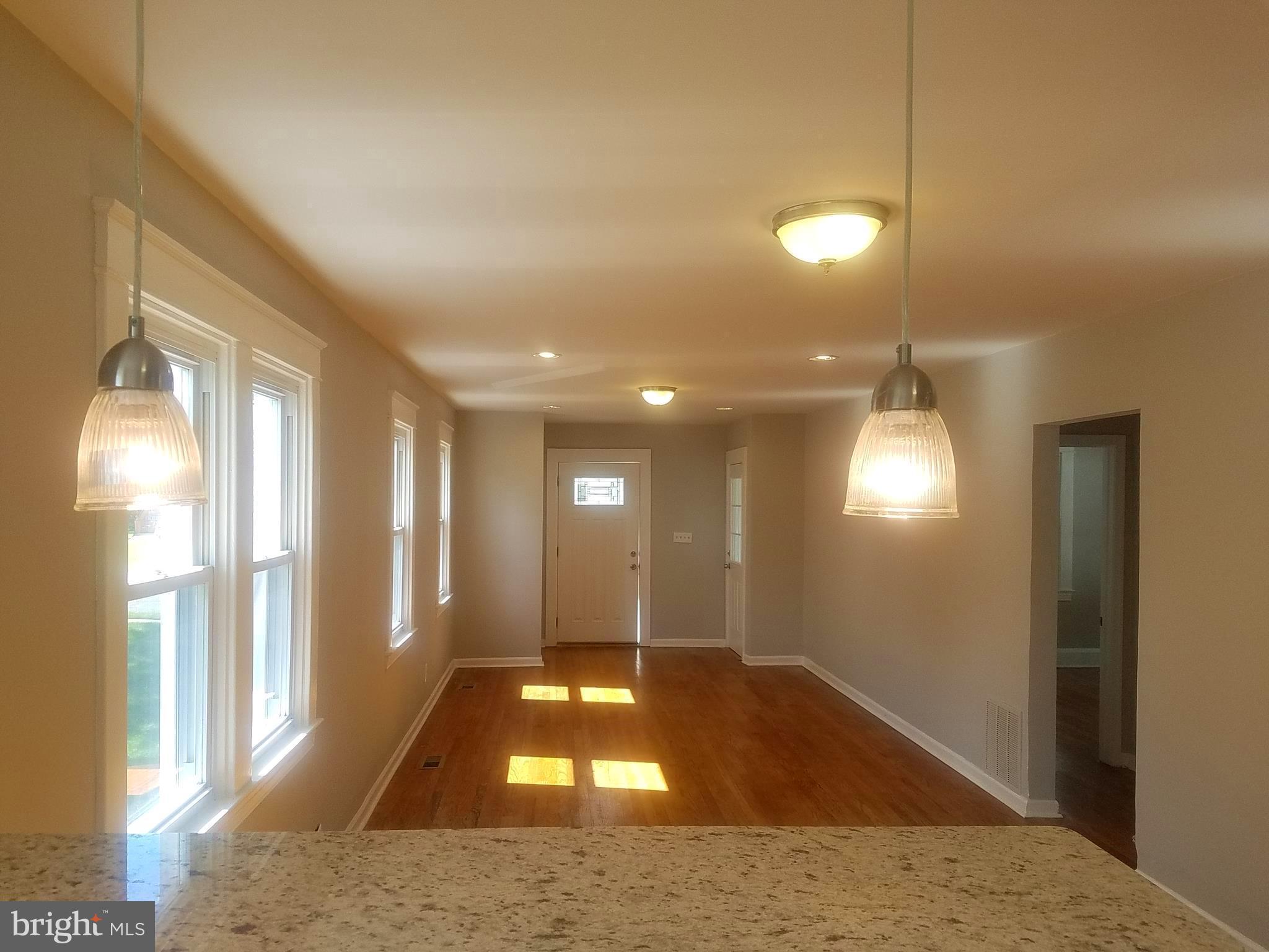 Renovated home in super convenient location. Updated new kitchen with breakfast bar & stainless steel appliances. The main level offers a open layout with living-dining-kitchen combo with 2 spacious bedrooms and warm hardwood floors. Upstairs is a master suite with walk-in closet and its own full bath.  Large lower with a full bedroom, living space and a 3rd full bath. Covered rear porch.