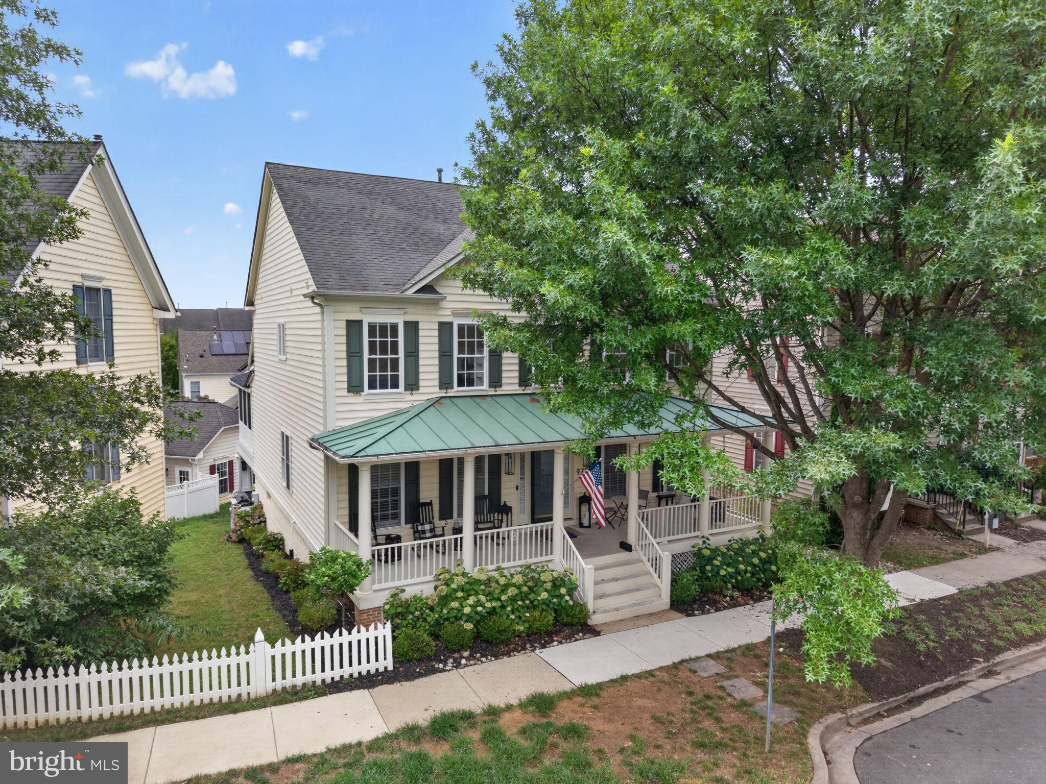 Welcome to 973 Main Street, an extraordinary 5-bedroom, 3 full bath, 1 half bath residence in the heart of Lakelands, where elevated design, exceptional functionality, and true neighborhood convenience come together in one of the community’s most desirable settings. Set within the award-winning Bartholomew model, this home has been meticulously transformed by its current owners into a modern farmhouse-inspired showpiece with luxury finishes, thoughtful upgrades, and custom details at every turn.

From the moment you enter, the quality of the renovation is immediately apparent. The flooring, lighting, fixtures, appliances, bathrooms, built-ins, and finishes have all been carefully selected and beautifully executed, creating a home that feels refined, cohesive, and remarkably livable. There truly is not a single surface that has not been thoughtfully considered. The result is arguably one of the finest modern farmhouse interpretations in Lakelands — warm, polished, stylish, and designed for the way people actually live.

The main level is an entertainer’s dream, offering an open, effortless flow between the kitchen, dining, living, screened porch, and outdoor spaces. At the center of it all is a fully renovated chef’s kitchen that is nothing short of a showstopper. Anchored by a dramatic 10-foot by 5-foot double-thick white quartz island, the space offers nearly 50 square feet of countertop surface for cooking, gathering, serving, entertaining, homework, conversation, and everyday life. Custom cabinetry, elevated finishes, a 48-inch Miele range, a 60-inch hood, premium appliances, two farmhouse sinks, wine and beverage coolers, and a massive walk-in pantry make the kitchen as functional as it is beautiful. Even the most thoughtful details have been considered, including a custom doggie faucet and built-in feeding tray — a charming and practical touch that reflects the level of customization found throughout the home.

The surrounding living spaces are equally impressive. A dramatic double-sided fireplace creates a true “wow” moment, bringing warmth, architecture, and visual impact to the heart of the home. Brilliant wide-plank hardwood floors, recessed lighting, paneled ceilings and walls, custom millwork, and luxury touches throughout create an atmosphere of refined resort-style living — all within the walkable, amenity-rich setting that makes Lakelands so beloved.

The owners also reimagined the home for modern daily life. The formal living room has been converted into a highly functional built-in locker area, creating a stylish everyday drop zone. The office has been fully renovated with custom built-ins, while the family room also features built-ins that add both beauty and practicality. A Sonos speaker system is integrated throughout the home and outdoor entertaining areas and will convey, along with several wall-mounted TVs, making the home feel truly turnkey for everyday living, entertaining, and relaxed luxury.

Just off the main living area, the screened-in porch functions as an inviting three-season room — a natural extension of the home and a place everyone will want to gather. Whether used for morning coffee, casual dinners, game days, quiet evenings, or effortless indoor-outdoor entertaining, it adds another layer of comfort and lifestyle appeal. The rear outdoor spaces continue the experience with a replacement deck and screened porch completed with Versatex, a fire table with inline natural gas, a full outdoor bar and kitchen area, and an outdoor built-in smoker.

Upstairs, the home offers one of the most valuable and sought-after layouts in the neighborhood: four full bedrooms on one level. This creates outstanding functionality for family living, guests, work-from-home needs, or flexible everyday use. The bathrooms have been thoughtfully renovated with elevated materials and fixtures, continuing the home’s cohesive design language and luxury-forward feel. The upstairs Carrier furnace was also