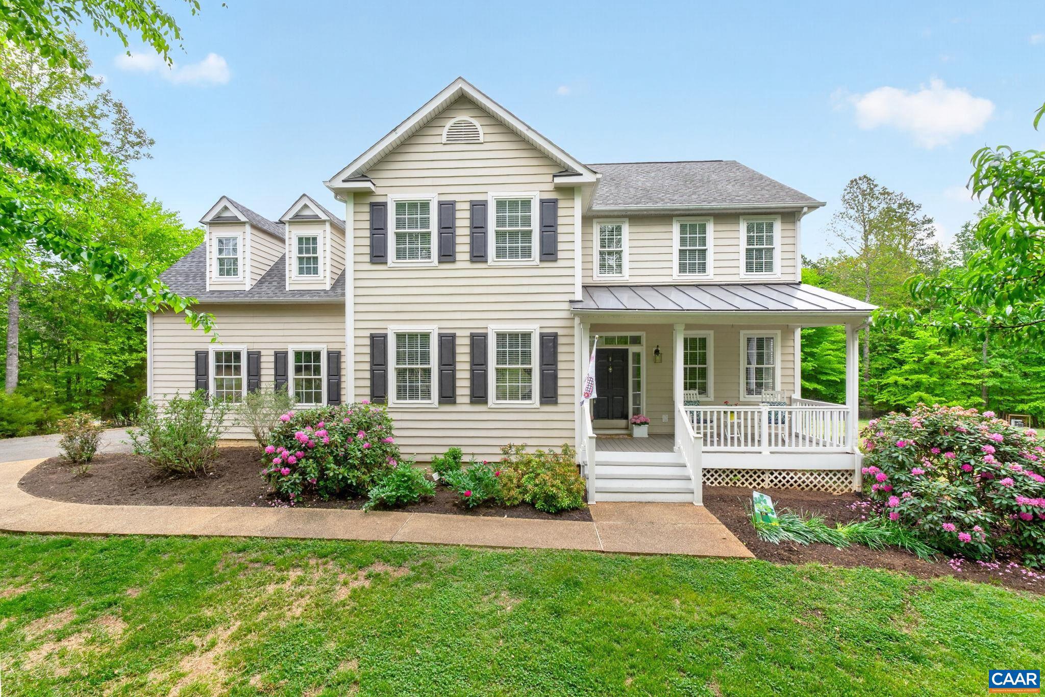 This beautiful colonial home is situated on 2.5 acres in one of Fluvanna County's most desired neighborhoods. This home has been meticulously maintained and updated with a new kitchen featuring quartz countertops, 42" white cabinets, subway tile backsplash, new appliances, a renovated master bathroom, refinished hardwood floors, fresh interior paint, and new Trex decking on the porches.  The main level offers a formal dining room, home office, and a great room that connects the kitchen, breakfast nook, and family room, which features a gas fireplace and built-in cabinets. Upstairs, you will find three bedrooms, a full bath, a playroom, and a master suite with an ensuite.  The basement is fully finished with a built-in bar, media room, bonus room, and a full bath. Outside, the rear deck overlooks a flat backyard featuring a fenced-in garden with raised beds, a playhouse, and a shed. The attached two-car garage also provides ample extra storage space.
