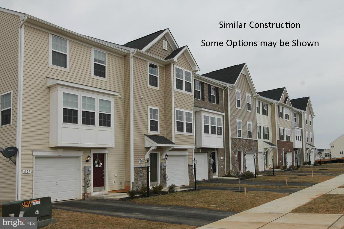Dan Ryan Builders at Stonebrook Village offers a new set of garage townhomes for September delivery. This beautiful end unit has 2 story box bay windows. Over 2300 finished sq.ft. on 3 levels. Hardwood floors in the big bright 12 ft. sunroom, kitchen & dining area. Upgrade cabinets & appliances. Oversized master bedroom & deluxe master bath. 2 room finished lower level with walkout to rear.