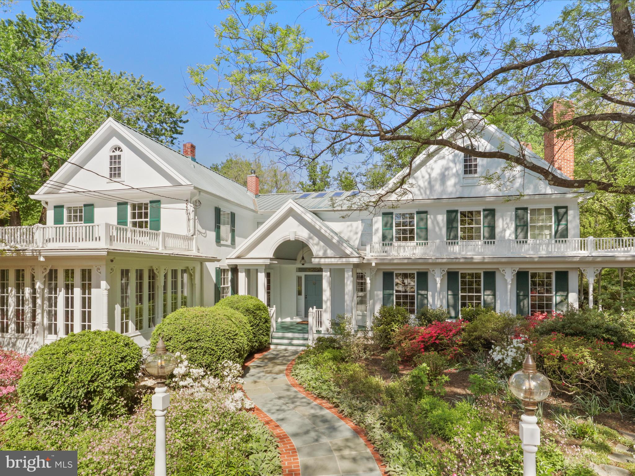 An entertainer’s dream, this exceptional Victorian home is ready to host any occasion with grace and style. From the moment you arrive at this 2-acre estate, a gated entrance with secure entry sets the tone for the privacy and exclusivity that await within. Meticulously designed and maintained, this property offers a rare blend of charm, modern amenities, and thoughtful functionality for today’s discerning homeowner.
Step into the stunning, light-filled two-story foyer featuring marble floors and a sweeping staircase. The upper level includes a luxurious primary suite with a fireplace, three additional spacious bedrooms—each with an ensuite bath—and a second-floor laundry room. A walk-up attic offers potential for additional living space.
The main level is perfectly suited for entertaining, with a formal dining room ideal for large gatherings, a cozy library, and an adjoining sunroom with skylights overlooking beautifully landscaped gardens. To the foyer's right, a window-lined living room and adjoining family room—each with wood-burning fireplaces and French doors opening to the wrap-around porch—offer inviting spaces for relaxation. The kitchen is outfitted with stainless steel appliances, a walk-in pantry, and an island. A breakfast area accommodates a large table with views of the Williamsburg-inspired gardens and a wisteria-covered arbor.
A three-car garage includes a fully finished upper level with a full bath and flexible space that can serve as a workout room or be converted into an in-law suite.
The outdoor amenities are equally impressive: a 1,000-square-foot pool house includes a fully equipped kitchen, covered patio, dressing room with full bath, steam room, sauna, and a finished upper-level home office with a full wall of picture windows overlooking the estate. The beautifully maintained grounds also feature a lighted, rubberized tennis court, a heated pool, and a hot tub, creating the ultimate private retreat for recreation and entertaining.
The charm and allure are truly beyond words.