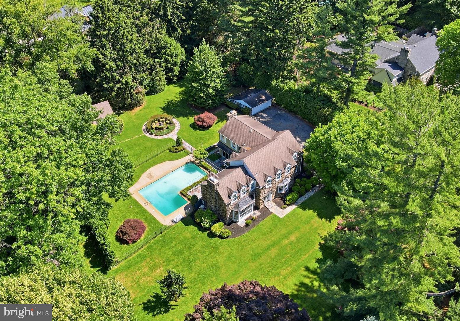 Set high above Righters Mill Road on a beautiful 1.05-acre lot in the heart of Penn Valley, this 5-bedroom, 3.5-bath classic stone Colonial offers the rare combination of location, scale, privacy, and long-term potential. The setting is the standout: mature trees, a gracious approach, broad lawn areas, a mostly level rear yard, pool, patio, garden areas, detached garage/shed, and a peaceful sense of separation from the street. Built in the 1940s and held by the same family for decades, the home offers more than 4,000 square feet of above-grade living space plus a finished lower level, with a traditional center-hall layout, large formal living room with fireplace, formal dining room, kitchen with breakfast area, expansive rear family room with stone fireplace and built-ins, generous bedroom space, and a large lower-level recreation room. While the home is ready for its next chapter and offers tremendous opportunity for renovation or customization, its classic stone exterior, substantial footprint, central air, forced-air heat, flexible floorplan, and exceptional lot create a compelling foundation. For buyers seeking a substantial Main Line residence on a premier Penn Valley property with privacy, pool, and upside, 727 Righters Mill Road is a rare chance to reimagine a home and setting that are difficult to replicate.