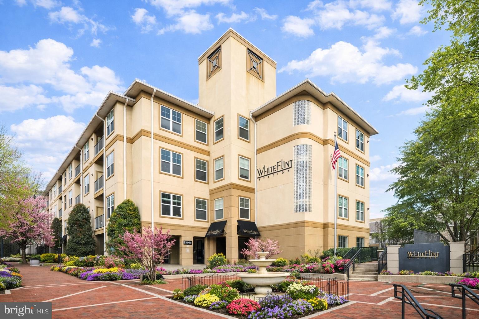 Welcome home to luxury living at White Flint Station in the heart of Rockville, where comfort and convenience come together in this beautifully designed 1,334-square-foot 2-bedroom, 2-bath condominium. From the moment you step inside, you’ll appreciate the bright, open layout filled with natural light from oversized windows and recessed lighting, complemented by hardwood floors throughout the living and dining areas. The well-appointed kitchen features stainless steel appliances, generous cabinetry, ample counter space,and a built-in nook perfect for work or study. From the living room step out onto your private balcony and enjoy peaceful views of the landscaped courtyard, along with the added convenience of a nearby ground-level exit just a few steps away.

The primary suite features hardwood flooring, a spacious closet, and an en-suite bath, while the large second bedroom provides flexibility for guests, a home office, or additional living space. Across from the second bedroom is the spacious laundry room which include a new high-end Samsung washer and dryer. This unit comes with the added convenience of two assigned parking spaces (#206 & #332). Monthly condo fees are $997.77.

Living at White Flint Station means enjoying a full-service lifestyle with resort-style amenities, including an outdoor pool, 24-hour fitness center, clubhouse, resident lounge, concierge service, on-site management, a dedicated bike room, and beautifully maintained courtyards with outdoor gathering areas. Ideally located just moments from Pike & Rose, the North Bethesda Metro, Rockville Pike, and major commuter routes, you’re perfectly positioned to enjoy shopping, dining, entertainment, and outdoor recreation all within easy reach. This is more than a home; it’s a lifestyle designed to be enjoyed.