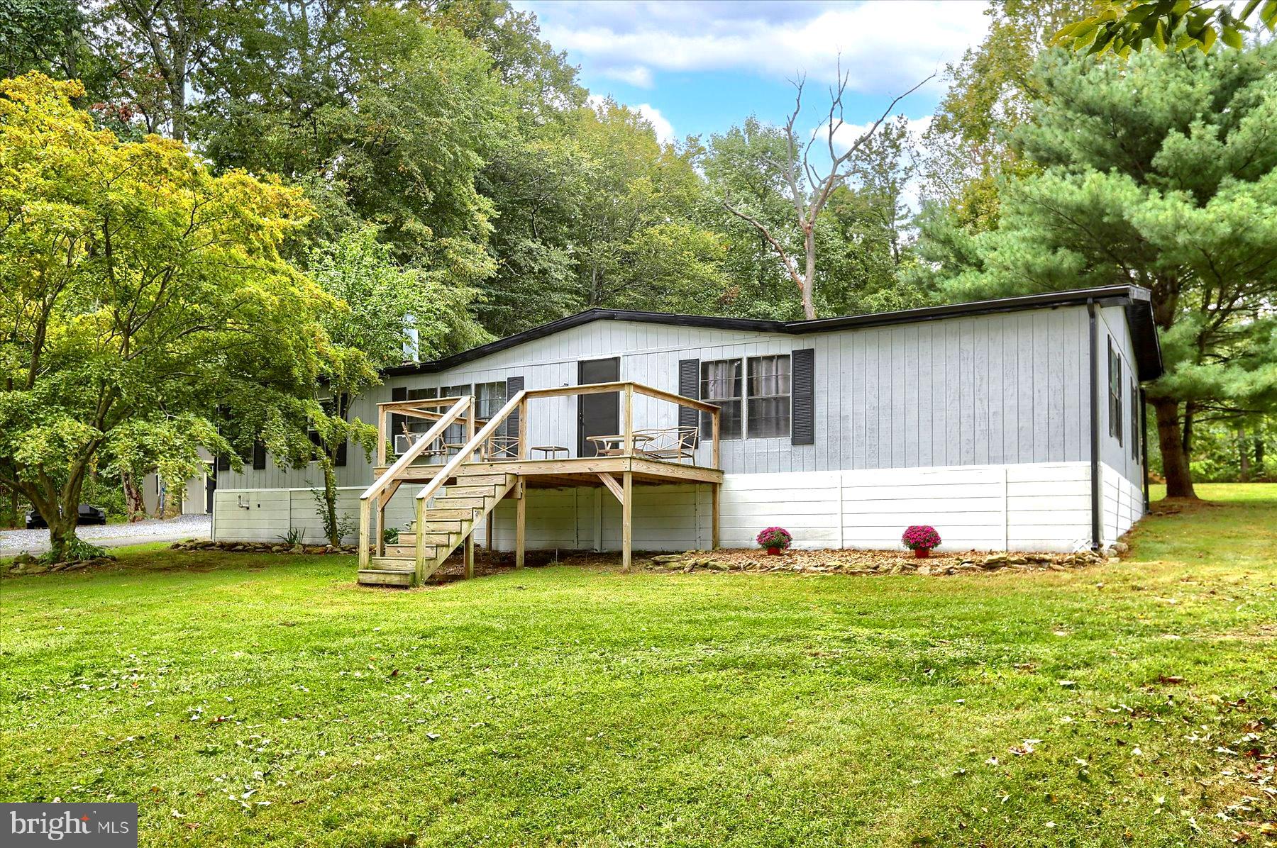 Unique chance to own a recently updated spacious three bedroom manufactured home! Along with the home you will own the large 25x25 ft detached garage, and above ground pool. All of this sits on a private 1.6 acre rented/leased lot (Not in a park) for your enjoyment. The home backs up to a wooded lot in a quiet cul-de-sac. Let the aromas of great food surround you in the large open kitchen with updated cabinets, backsplash, granite counter tops and flooring. Gather with friends and family around the large island, or  in the open dining area and then enjoy a movie in front of the wood burning fire place in the large living room. The master bedroom has an attached updated bathroom with walk in tile shower. Utilize the large detached garage for your car or wood working dreams.  End your day sitting on one of the large front or back porches taking in the sunset. Roof was replaced in 2019. Lot rent/land lease is $550.00 includes maintenance of the well and septic. (You will NOT own the land).  Call today for a showing!
