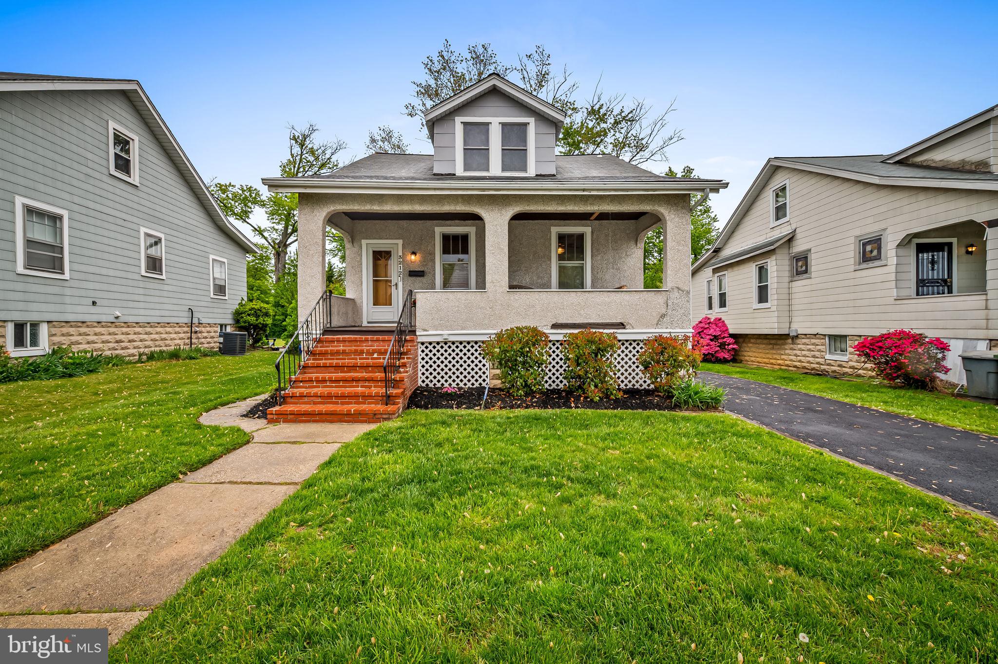 With approximately 2,000 sq. ft of finished space, this 4 bedroom, 2.5 bath "tabby-shell" stucco cape cod home in sought-after Hamilton Heights offers a blend of original character and thoughtful updates including the option for a main level primary bedroom! You'll love the covered front porch (with swing!) that welcomes you into a light-filled living room featuring stained glass accents, a decorative fireplace with wall sconces, and hardwood inlay floors. The dining room flows seamlessly into an updated kitchen with maple cabinetry (soft-close), granite countertops, subway tile backsplash, pantry storage, stainless steel appliances, gas cooking, and so much more.

The main level includes two bedrooms with hardwood floors, along with a beautifully renovated full bath (2021). Upstairs, you’ll find two additional bedrooms—both with hardwood floors and generous closet space—plus an updated full bath with double vanity and ceramic tile.

The finished lower level offers flexible living space with recessed lighting, built-in cabinetry, a stylish wet bar, powder room, and a large utility/laundry/storage area with walk-out access to the rear yard.

Outdoor living is equally appealing with a spacious deck, fenced level yard, and a gas line for convenient grilling. Recent improvements include a newly paved driveway and freshly painted interior spaces, enhancing both curb appeal and move-in readiness.

Important updates include dual-zone HVAC (2019), stainless steel appliances (2018), main level bath renovation (2021), and upper-level hardwood flooring (2015).