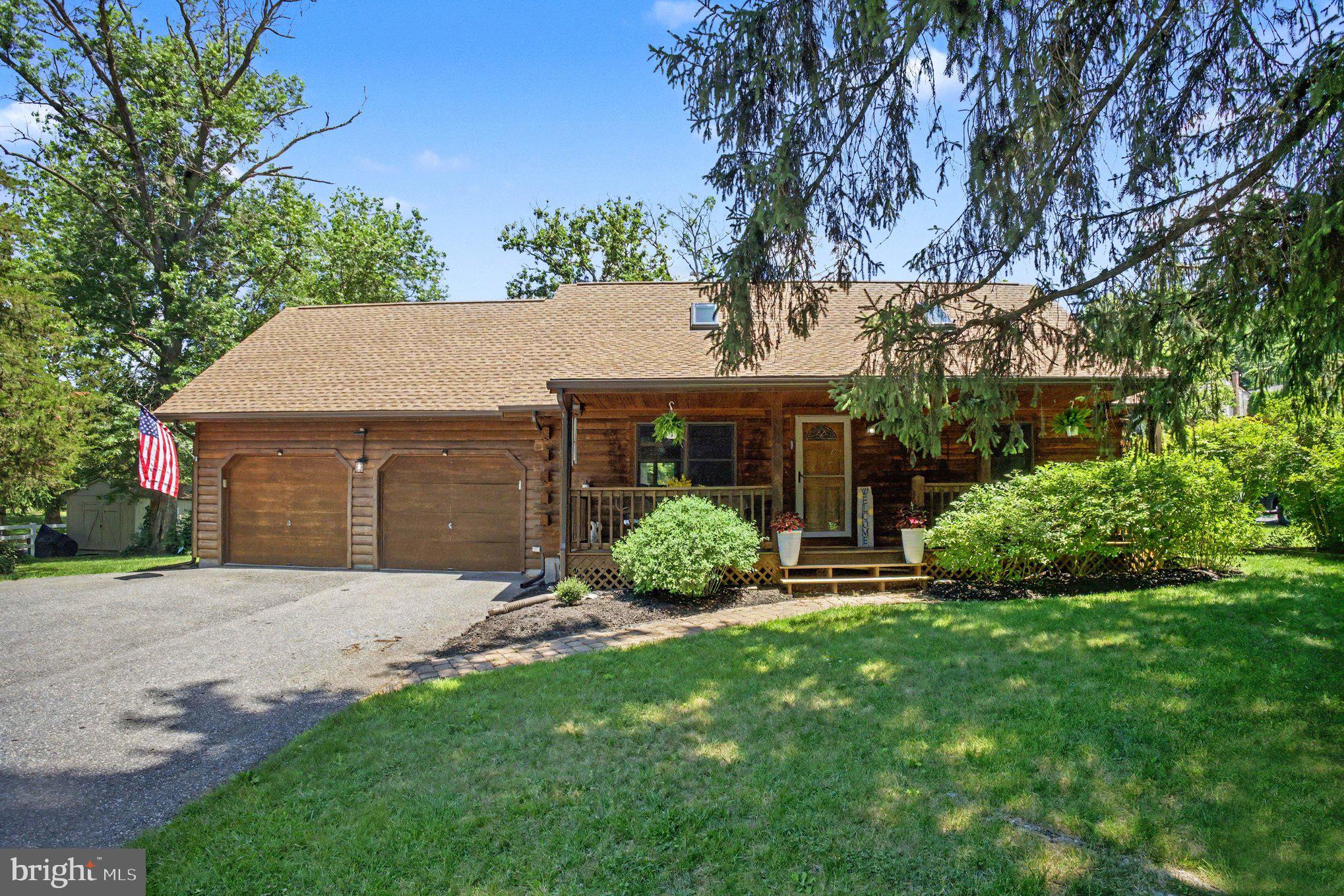 Escape the ordinary with this charming, well-maintained log cabin nestled on a quiet, partially wooded lot in beautiful Elizabethtown, PA. This home seamlessly blends the rustic, cozy aesthetic of cabin living with modern updates that provide peace of mind.

Step inside to a spacious, light-filled layout. The heart of the home features a classic stone hearth propane fireplace, perfect for relaxing on chilly evenings. You can move in with confidence knowing the major systems have been recently upgraded, including:
New Roof: Providing years of worry-free protection.
Climate Control: Brand new furnace and high-efficiency AC (indoor and outdoor units).
Modern Comforts: Power-shaded skylights, updated carpeting, and a new water softener.
Versatile Spaces: The partially finished basement has been refreshed with new paint and carpet, offering the perfect spot for a game room or den.
The upper level is a showstopper, featuring a massive, open loft-style bedroom with dedicated office space and a large walk-in closet, plus an additional bonus room that offers endless potential as a guest space or hobby area. Tasteful window coverings are included throughout.

Your backyard is truly a private sanctuary. The property abuts an open private pond lot, complete with a lighted water fountain that creates a stunning, serene backdrop for your summer evenings. Whether you are a gardening enthusiast or a nature lover, you will appreciate the enclosed organic raised bed garden and the lush, mature landscaping with established flower beds. The classic covered front porch is the ideal spot for morning coffee, and a new, large shed provides ample storage space.

Living in Elizabethtown means you are perfectly positioned for both relaxation and adventure:
Outdoor Recreation: Enjoy miles of scenic walking and biking along the popular Conewago Recreation Trail.
Local Culture: Explore the historic charm of downtown Elizabethtown, enjoy the arts and events at Elizabethtown College, or discover unique local shops and eateries.
Central Convenience: You are centrally located with easy, quick access to the world-class entertainment and theme parks of Hershey and the rich, scenic culture of Lancaster County.
Note: The air compressor, freezer, TVs, basement refrigerator, and water cooler are excluded from the sale.