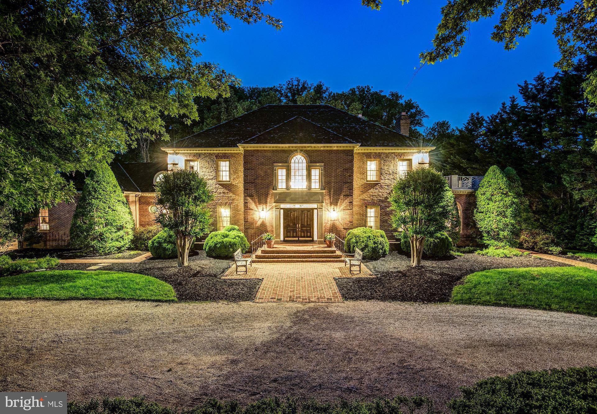 MAJOR PRICE REDUCTION ***24 hour notice please***  First showings this week (owner has houseguests) will be Tuesday on. Spectacular light filled Georgian perfect for year round entertaining!  From the full length solarium to the warm and inviting covered porches, this residence welcomes you with custom millwork and lighting worthy of a grand estate home.  The gated entry opens to a circular drive with ample parking for up to ten cars. The wide front entry porch leads to the high ceilinged foyer with dual curved staircases.  High ceilings and custom mouldings abound from the formal living and dining rooms, to the grand  paneled library with fireplace. Located centrally in the home, the gourmet kitchen with center island opens to a full length solarium/family room and music room.   French doors lead to a spacious covered wood porch.  Views of the pool, outdoor kitchen and lush landscaped grounds along with an outdoor fireplace can be seen from multiple levels of the home.   The second story features 5 spacious bedrooms and four full baths including the owners suite that provides more than ample wardrobe space.  A second staircase from the kitchen side of the home also allows access to the bedroom level.  The lower level offers a billiards room, living room, wine storage, den with full bath, bedroom with full bath and an additional swimming pool bathhouse (also with full bath).  Enjoy the expansive outdoor patio with kitchen, outdoor fireplace and swimming pool.  A picturesque setting that envelopes the sense with extraordinary landscaping and views.  This is the perfect setting for formal and informal entertaining and provides all of the requirements for todays home office needs and outdoor living areas.  A three car garage completes this extraordinary offering. Major addition completed by BOWA Builders in 2000, and an outdoor kitchen/pool/fireplace added in 2011.