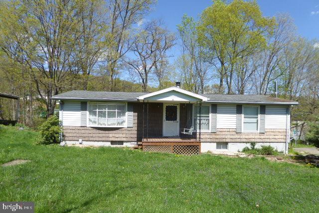 CALL TODAY TO SEE THIS COZY 2 BEDROOM HOME THAT SITS ON A .59 AC LOT. THE FRONT DOOR OPENS INTO A WELCOMING FOYER WITH COAT CLOSET AND ENTERS INTO THE LIVING ROOM. THE KITCHEN HAS ITS OWN ENTRANCE FROM THE SIDE MAKING IT EASY TO BRING IN GROCERIES! THE KITCHEN FEATURES A GAS STOVE, AN ISLAND, PANTRY AND A WINDOW ABOVE THE SINK. THE SLIDING GLASS DOOR FROM THE DINING ROOM EXITS TO A NICE COVERED BACK PORCH. THE 2 BEDROOMS, FULL BATH AND HALF BATH ARE JUST DOWN THE HALL. YOU WILL SEE THAT STAIRS HAVE BEEN INSTALLED PROVIDING AN INDOOR ACCESS TO THE PARTIALLY FINISHED BASEMENT. THE LOCATION IS IDEAL AS YOU ARE SO CLOSE TO TOWN BUT NOT IN CITY LIMITS.