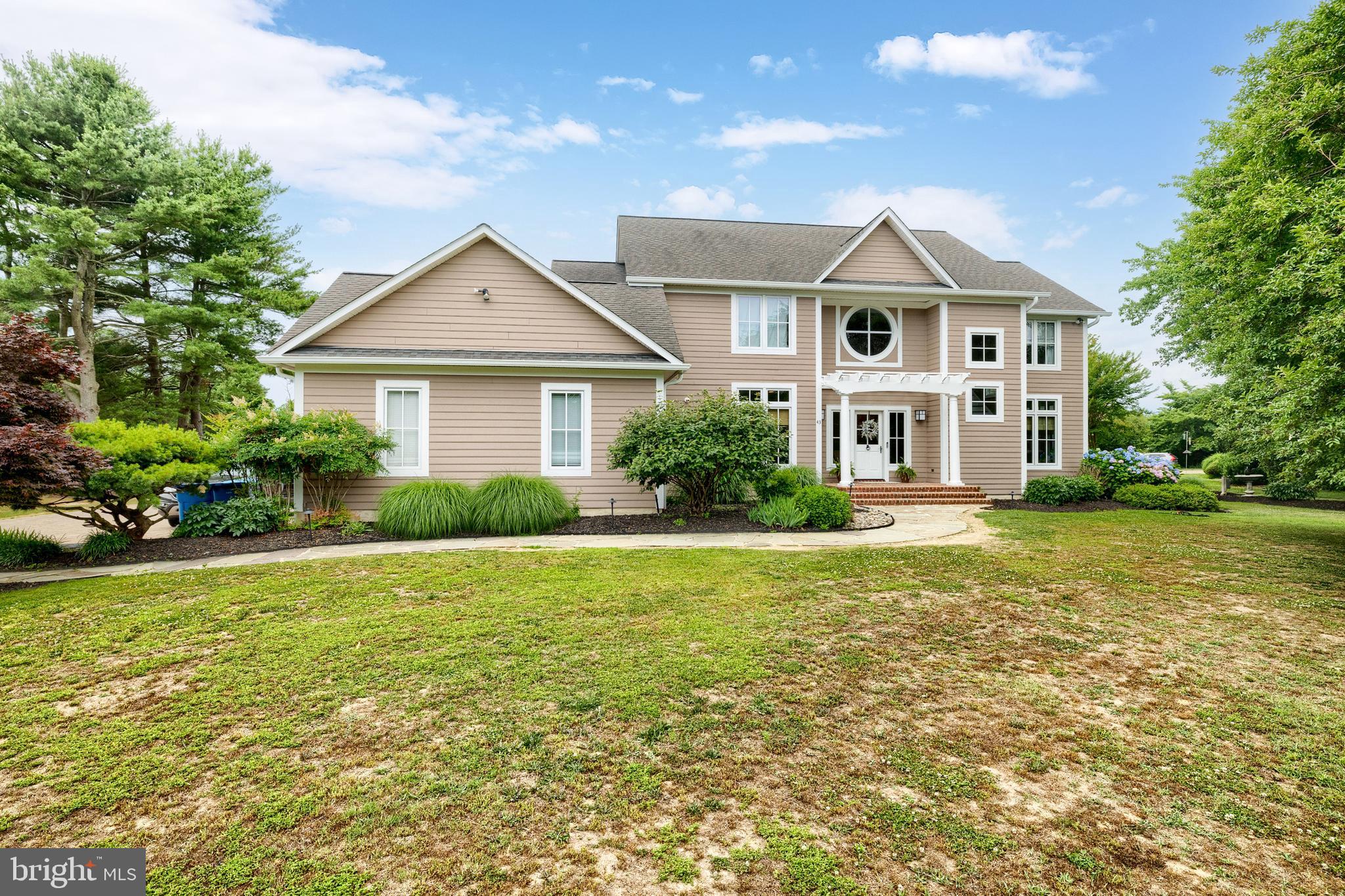 Tucked behind mature trees on a private 1.02-acre lot with a creek glimpse from the home, this 4,000+ sq ft coastal home sits inside Prospect Bay, Grasonville's premier golf communities — and it lives every bit as well as it looks.
The kitchen is the showpiece. Built for the cook who loves to entertain, it's outfitted with high-end commercial-grade appliances, including a commercial range, anchored by a center island and a walk-in pantry — ready for everything from weeknight dinners to holidays with a full house. Rich hardwood floors run throughout, framed by 9'+ ceilings, crown molding, and recessed lighting that give every room a warm, finished feel.
There's room to spread out and room to unwind. A spacious living room addition and a screened-in porch extend the everyday living space, while out back the deck, fenced in-ground saltwater pool, and dedicated pool house turn the private yard into a true retreat. The primary suite is its own escape, with an attached bathroom that features double sinks and luxury shower, walk-in closet, and private deck access.
Three bedrooms, 3.5 baths, a formal dining room, a dedicated office, and a side-entry two-car garage complete the floor plan — all behind a classic hardiplank exterior built to last.

Then there's the lifestyle. Prospect Bay is a resort-style community wrapped around an 18-hole golf course, with access to a community pool, tennis and pickleball courts, and a clubhouse with casual and fine dining. A private community waterfront adds a marina, boat ramp, pier, and kayak launch with available storage. You're roughly ten minutes from the Bay Bridge, 25 minutes from Annapolis, Easton, and St. Michael's, and about an hour from Baltimore and D.C.

Homes of this size rarely come available here. If you've been waiting for the right home on the Shore — this is it.