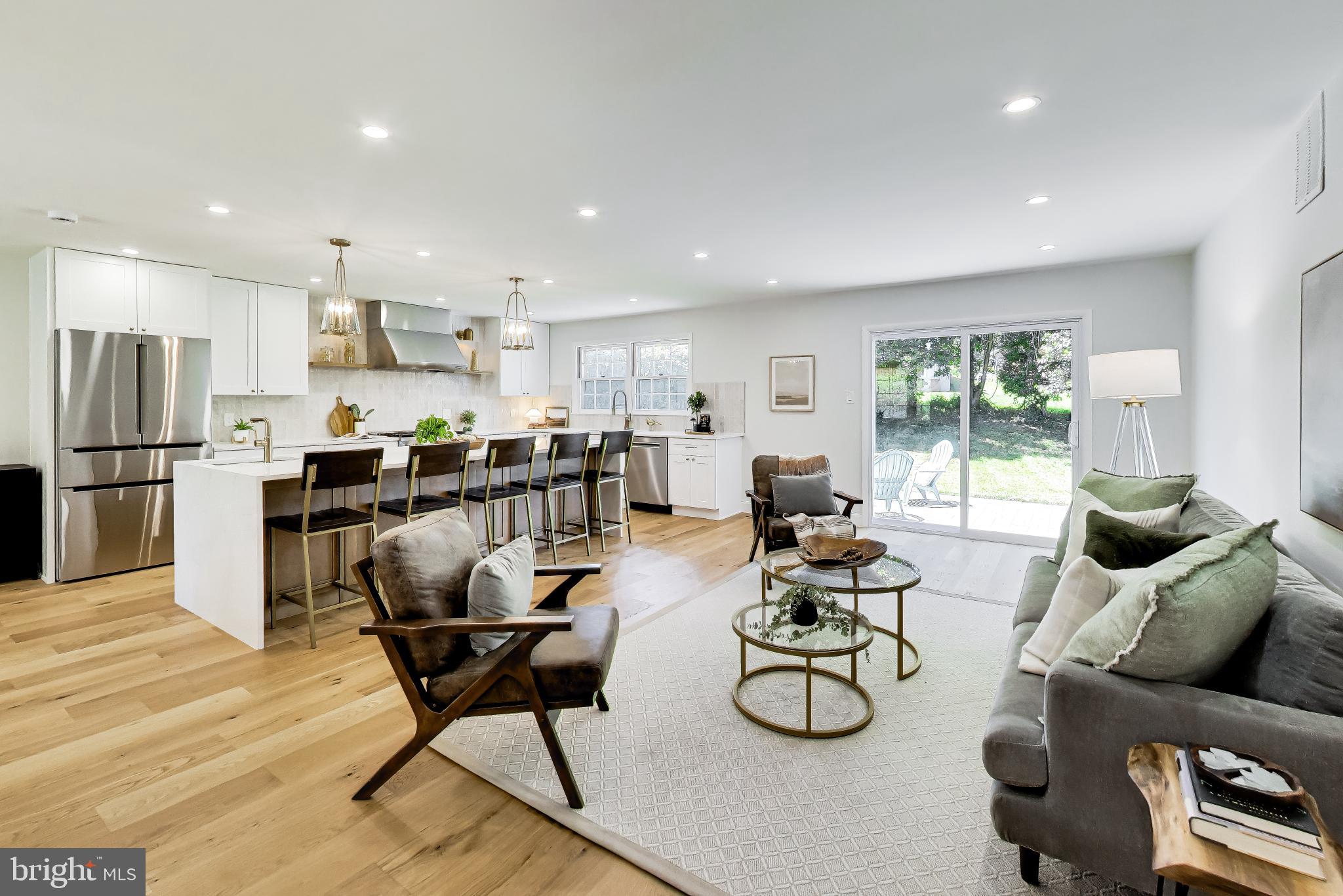 Welcome to this beautifully renovated home where modern design meets everyday functionality. The heart of the home is the stunning open-concept kitchen, featuring an over 10  foot luxurious center island with quartz countertops and seating for five. The kitchen is thoughtfully appointed with abundant cabinetry, a gorgeous designer backsplash, a large undermount sink, and a separate prep sink for added convenience. Luxury finishes include quartz countertops, new lighting, stainless steel appliances and wide planked natural wihte oak floors. The kitchen seamlessly flows into the spacious dining and living areas, creating the perfect setting for entertaining and daily living. Sliding glass doors lead to a brand-new paver patio, offering an ideal outdoor retreat for dining, relaxing, and gathering with family and friends.
Upstairs, you'll find a generously sized primary bedroom with a beautifully appointed ensuite bath featuring dual sinks and striking tiled walk in shower. Three additional bedrooms and renovated hall bath with custom tile, updated fixtures, vanity, and mirror offers both comfort and convenience for family members and guests alike.
The versatile lower level features a welcoming family room with a fireplace, a brand-new full bathroom, a private office perfect for working from home, and a new washer and dryer. Walk-out access to the side yard adds convenience and flexibility to the space.
Thoughtfully renovated throughout, this exceptional home combines stylish finishes, functional living and timeless design, offering a seamless blend of comfort and sophistication in every space.
Perfectly situated for everyday ease and lifestyle convenience, the home is just moments from premier shopping and dining, schools, and key commuter routes and walkable to all three schools - a compelling opportunity in every sense.