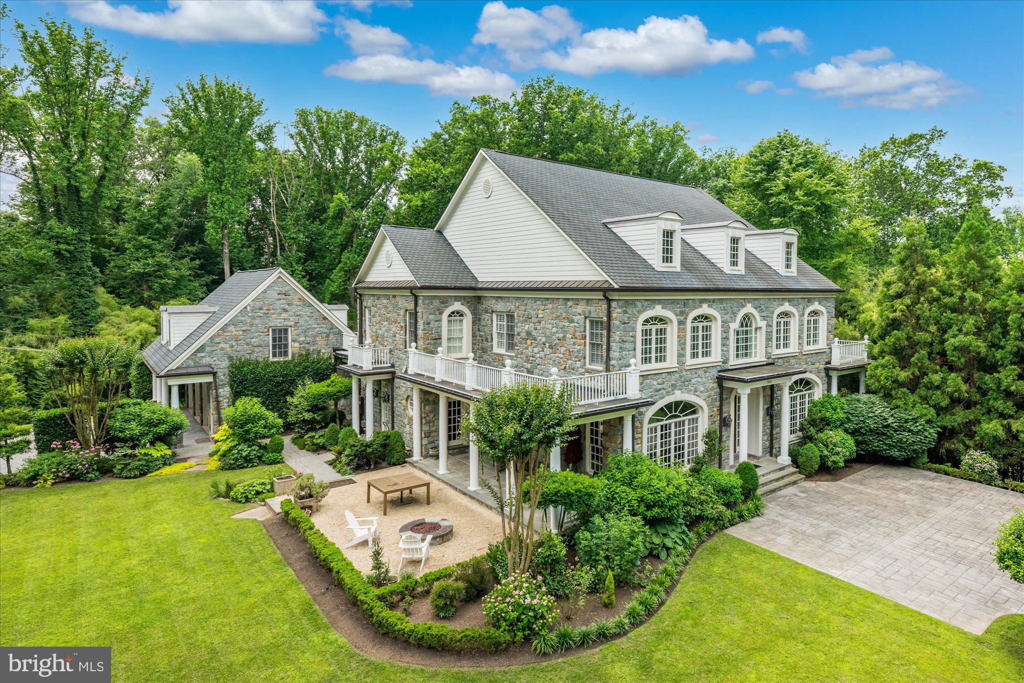 Located in one of the most sought after parts of Northern Virginia, ideally located between downtown Washington D.C. and Tyson's Corner with easy access to both Reagan National & Dulles International airports. Refined craftsmanship, ornate wood trim and moldings, and the finest materials come together to make this light-filled stone Georgian a true masterpiece.  The inviting floorplan offers generously sized rooms while retaining the warmth desired for private relaxation and the classic elegance sought after for sophisticated everyday living. As you enter the grand foyer, find the formal living and dining rooms on either side. Down the hall, the large family room hosts a fireplace, a detailed ceiling and a private working library with built-ins—a gourmet chef's kitchen with Viking appliances. On the second floor, find the spacious primary bedroom with fireplace, sitting area, walk-in closets, and an exquisite ensuite bath plus three additional large bedrooms all with ensuite baths. The lower level boasts a walkout rec room with a fireplace, a built-in bar area, a separate billiards room, a guest room with a full bath, and a wine storage room. Gleaming hardwood floors and tall ceilings throughout.   Two levels of balconies overlook the wooded views and professionally landscaped yard. Above the 3-car garage, you will find an expansive private office space/ guest suite. McLean's beautiful landscape, prestigious neighborhoods,  and boundless opportunities for community involvement make it the preferred destination for the Capital area's most refined residents. Septic approved for 5 bedrooms. Clothes washer in As-Is Condition.