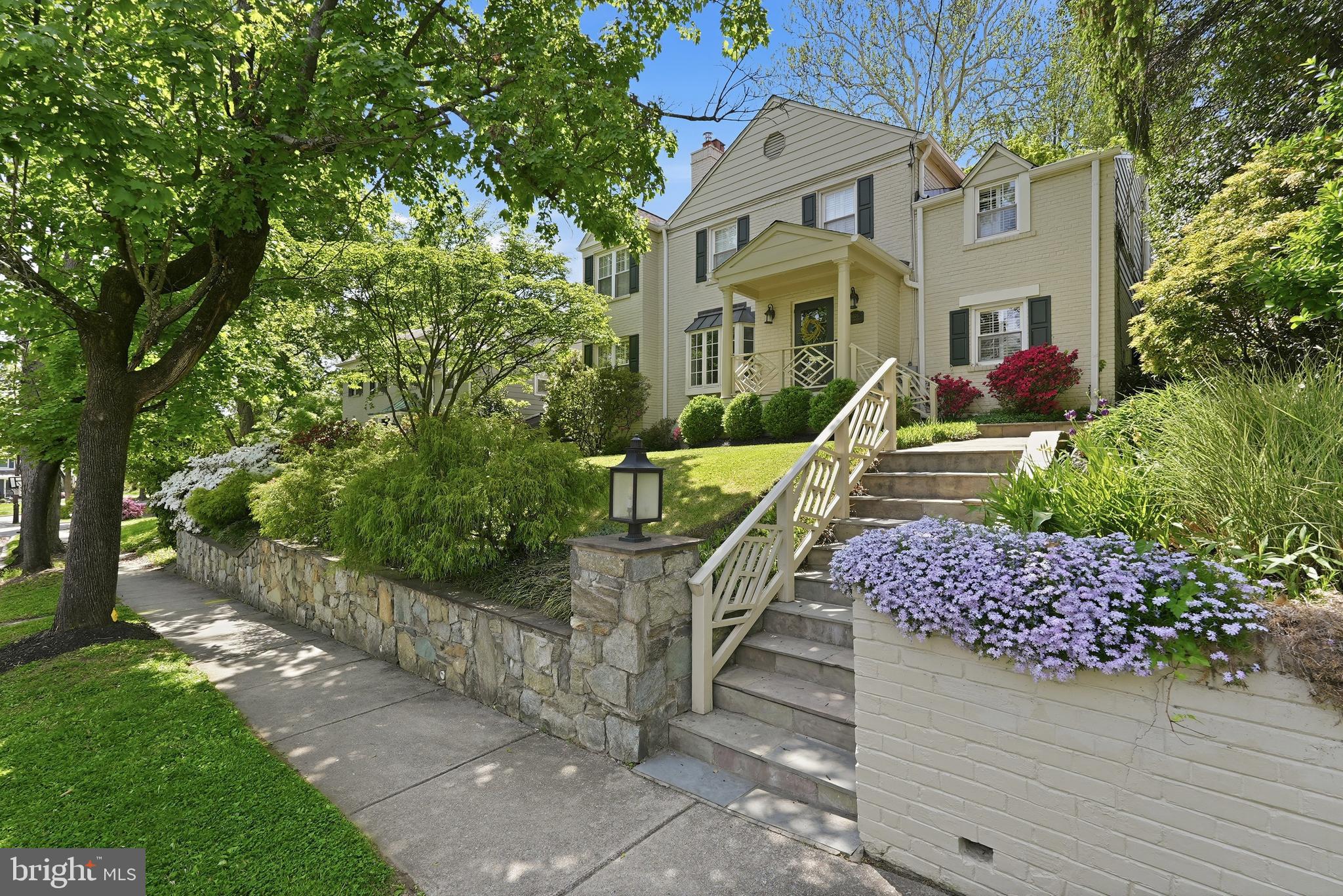 Perched gracefully on a quiet, tree-lined street in one of the most coveted neighborhoods in Chevy Chase, this stately brick Colonial blends timeless architecture with thoughtful renovations and expansions completed over time. Originally built in 1937, the home offers beautifully proportioned living spaces, enduring character, and modern comfort across three finished levels. Rich hardwood floors, elegant crown moldings, and plantation shutters throughout enhance the home’s classic appeal and refined aesthetic.
 
A welcoming entry introduces elegant main-level living spaces designed for both everyday living and gracious entertaining. The formal living room is anchored by a wood-burning fireplace, while the formal dining room is tucked away to provide an intimate setting for family dinners or holiday meals. The renovated kitchen with its marble countertops, extensive food prep space, and plentiful cabinetry connects seamlessly to the family room addition, creating a cohesive flow for everyday living. Multiple entryways off the back of the house add to the connectivity of indoor-outdoor living. A private home office and powder room complete the main level.
 
Upstairs, four well-scaled bedrooms and three full baths include a beautifully appointed primary suite with a large spa-inspired bathroom and an exceptional light-filled dressing room. Three additional bedrooms offer flexibility for family, guests, or secondary office space.
 
The lower level includes a comfortable recreation room along with a large laundry and storage area, as well as a convenient full bathroom. Outside, the driveway leads to an attached one-car garage, complemented by a separate storage shed and a spacious patio perfectly suited for grilling, outdoor dining, and entertaining.
 
Surrounded by mature landscaping, including stunning azalea bushes and a lush, leafy setting, the property offers an ideal balance of neighborhood charm and everyday convenience.
 
Adjacent to Columbia Country Club and located just moments from neighborhood amenities like Starbucks and the newly transformed Chevy Chase Lake development with its restaurants, pharmacy, and fitness options, and with easy access to Washington and the Beltway, this is a truly special offering in a premier location.