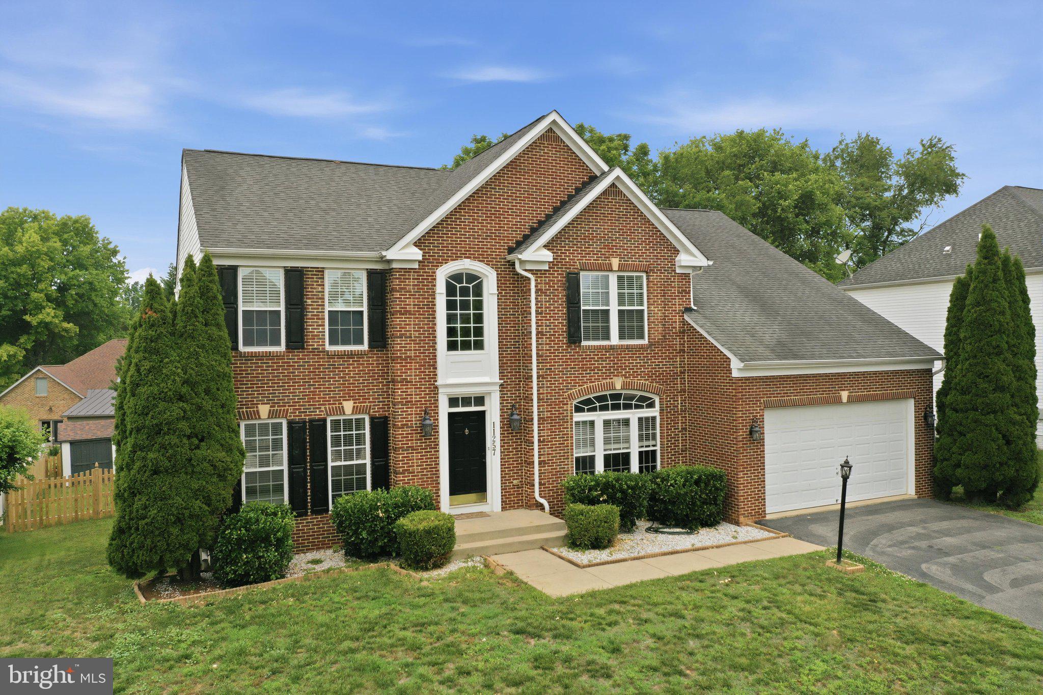 Nestled in the prestigious Hamptons of Brightwood, this exquisite Colonial residence exudes timeless elegance and modern comfort. Built in 2004, the home showcases a stunning brick front and vinyl siding, harmonizing classic architecture with contemporary design. Spanning an impressive 4,853 square feet, the interior boasts a seamless flow, enhanced by rich hardwood flooring. Step inside to discover a gourmet kitchen, a culinary enthusiast's dream, featuring upgraded countertops, stainless steel appliances, and a spacious island perfect for entertaining. The open floor plan invites natural light, creating a warm ambiance throughout the family room, which is anchored by a cozy gas fireplace, ideal for intimate gatherings. The main level also includes a charming breakfast area and a formal dining room, both designed for effortless hosting. Ascend to the upper level to find four generously sized bedrooms, including a luxurious primary suite complete with 2 walk-in closets and an opulent en-suite bath featuring a jetted tub and stall shower. The fully finished basement offers additional living space, complete with a rough-in for a future bath, and convenient walkout access. Outside, enjoy the serenity of your covered private porch, perfect for alfresco dining or morning coffee. With a two-car attached garage and a newly fenced yard, this home is a true sanctuary. Experience the perfect blend of craftsmanship and modern amenities in this remarkable property, where every detail has been thoughtfully curated for luxurious living.