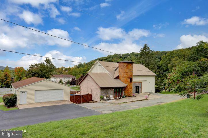 Step into a truly one-of-a-kind property rich with history, character, and endless possibilities. Originally part of the historic Nittinger Farm and dating back nearly 200 years, this remarkable home blends timeless charm with thoughtful modern updates. Original barn features remain throughout, while every inch has been creatively restored with custom woodwork and unique details that make this property unlike anything else on the market.

Since previously listed, the owners have completed even more of the space, adding a potential fourth separate living area complete with its own bathroom and private access. This addition creates even more opportunity for short-term rental income, multi-generational living, guest accommodations, or flexible use to fit your needs.

In addition to the beautifully updated home, the property features a spacious 2,500-square-foot workshop offering incredible flexibility. Whether you’re searching for a primary residence, multi-generational living opportunity, Airbnb or rental investment, potential bed & breakfast, event venue, or a property with space to operate a business, this exceptional property can accommodate it all.

Three of the four living areas come completely stocked, furnished, and ready to operate as short-term rentals, creating an incredible turnkey income-producing opportunity.

Outside, enjoy your own private backyard oasis complete with a heated saltwater pool — the perfect place to relax, entertain, and enjoy the setting.