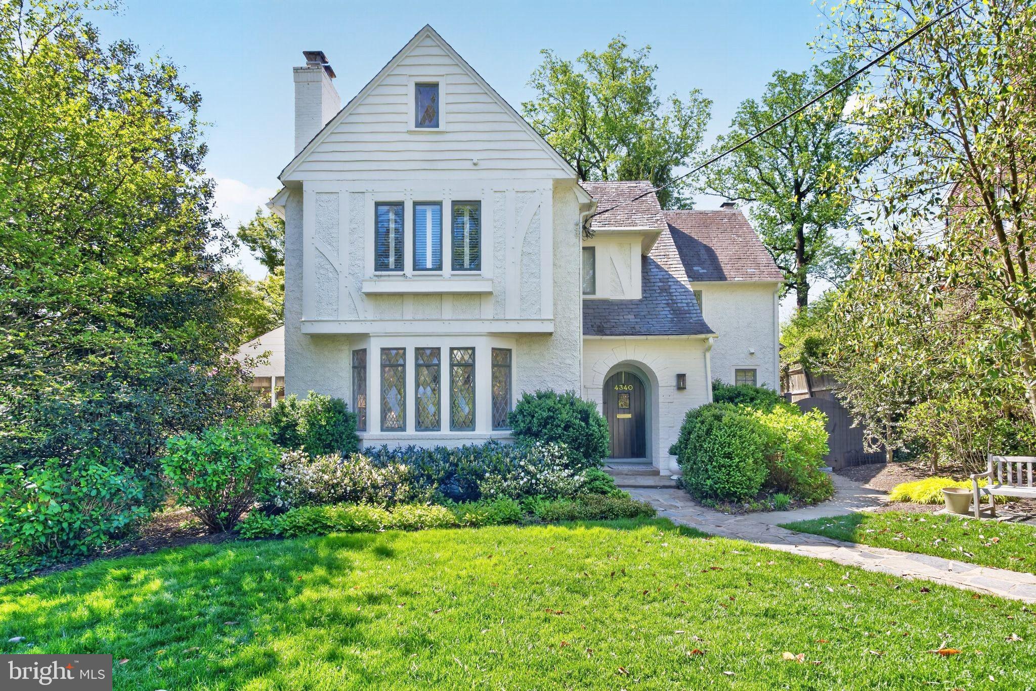 This elegant Tudor in sought after Wesley Heights presents a rare union of architectural pedigree, a thoughtfully updated interior, and private grounds with a pool. Featuring six bedroom and five and a half baths, this residence has been meticulously maintained and tastefully updated, preserving the craftsmanship of it's era.

The main level is composed with a clear sense of formality and flow. A gracious living room, anchored by a handsome fireplace, opens to a formal dining room that accommodates a table for eight. A library extends from the main reception rooms and open directly onto the pool terrace. The renovated kitchen has been appointed with marble counters and a Thermador range, and it opens gracefully to a family room with a fireplace and built-in banquette, forming the natural heart of the home.

The bedroom level has been arranged with equal attention to comfort and privacy. The large primary bedroom features a generous walk-in closet and a primary bath that is finished in marble and features double vanities, a freestanding soaking tub, a separate shower. A guest bedroom with ensuite bath and  two additional bedrooms served by a full bath with marble vanity. The top floor offers a fifth bedroom and a newly completed full bath, providing a versatile suite suited to guests or extended family. The lower level contributes further living space, including a substantial family room, an additional bedroom, and a full bath.

The grounds are equally considered. A beautifully proportioned yard is anchored by a private pool, and a dedicated garage rounds out a property that delivers what is exceedingly rare within the District: privacy, scale, and convenience in equal measure. This Wesley Heights residence represents a singular opportunity for the buyer seeking a home of enduring character and style.