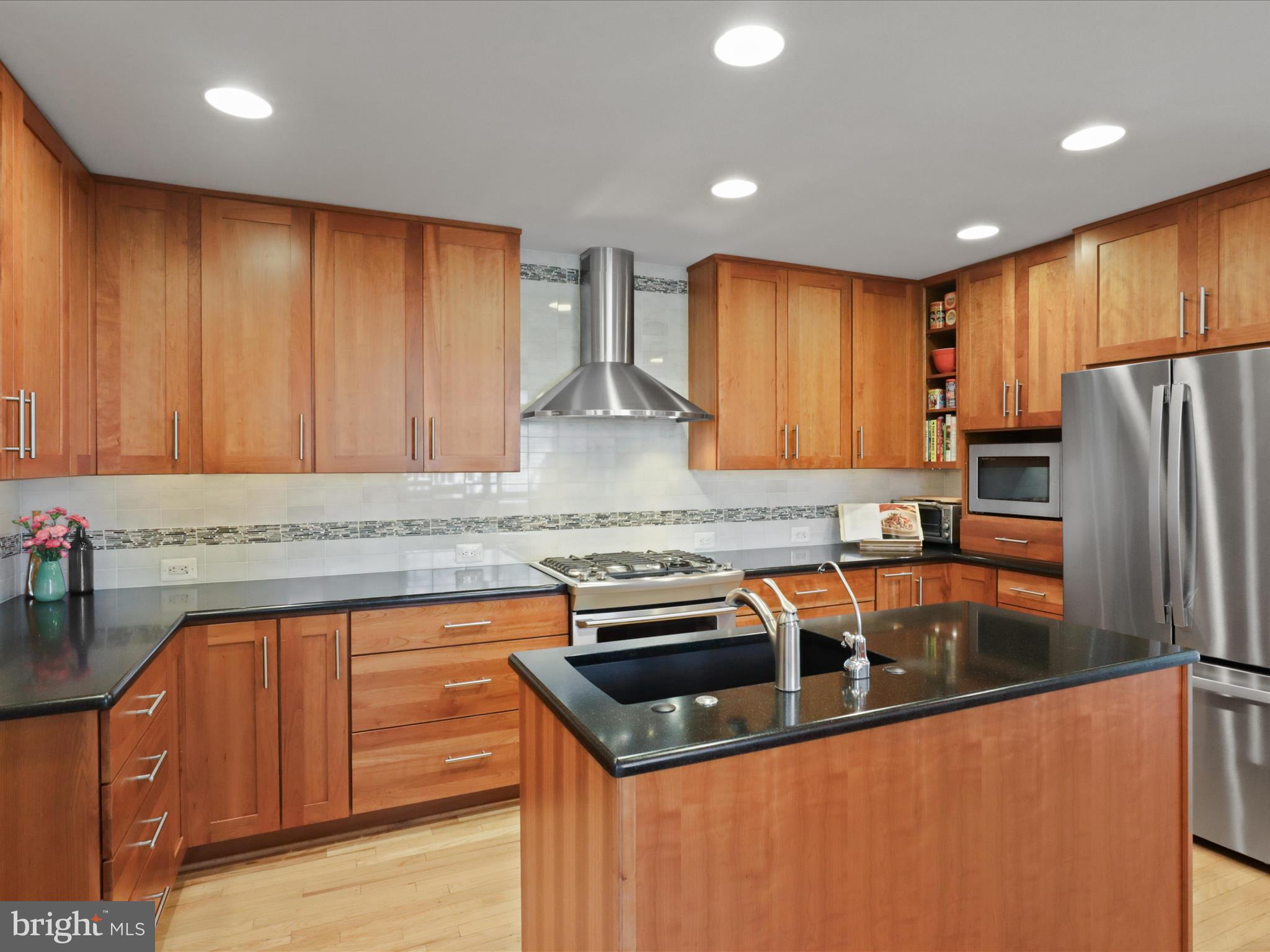 Prime Location & Incredible Features Await You!

This charming home is ideally located just a short 10-12 minute walk to Ballston Metro, offering easy access to the heart of Arlington and beyond. Enjoy the convenience of being within walking distance to the bike trails, vibrant shops, and a variety of dining options. Nestled on a quiet, peaceful street, the home is located within the Washington-Liberty High School district.

The fabulous lot boasts a spacious, relatively flat yard that provides a perfect outdoor oasis. With a welcoming front porch, a sunny rear deck, and a screened porch, you will find plenty of space to relax and entertain in this peaceful setting.

Inside, the home is flooded with natural light, featuring high ceilings, an open floor plan, and skylights. Beautiful hardwood floors throughout most of the main level add warmth and character to the space. The main floor also includes a bedroom with an adjacent full bath, making it an ideal option for guests or multi-generational living. The living room area includes a gas-ready wood-burning fireplace open to the sunny dining area all washed with natural light from the two story ceilings, beautiful windows, and skylights.  The adjacent family room can be separated by glass pocket doors with built in shades for privacy.  Enjoy the designer ceiling fan and sliding glass doors, which leads to the backyard or screened porch, providing a seamless flow between indoor and outdoor living.

The kitchen, renovated in 2010, is a chef’s dream, featuring upgraded custom cabinetry with pull-out shelving, a center island, stainless steel appliances, and a large sink.  There is a touch of Frank Lloyd Wright flair in the glass cabinetry.   A separate filtered water dispenser adds a thoughtful touch for added convenience. 

Upstairs, the home offers three spacious bedrooms, including a primary suite with high ceilings, a private balcony overlooking the rear yard, a built-in laundry hamper, and a walk-in closet. The primary bathroom is beautifully appointed with skylights. Two additional bedrooms are connected by a Jack-and-Jill bath, and the bedroom level also includes convenient laundry and access to the attic for additional storage.

The finished lower level provides a large second family room, with white bookshelves and cabinetry that will convey. This space is perfect for relaxing or hosting guests, with a potential bonus room that could serve as an exercise room, home office, or playroom. Additional features include a second refrigerator, ample storage, and a built-in workbench.

Truly an outdoor oasis, step into the exquisitely  landscaped, partially fenced rear yard, where you can enjoy outdoor living to the fullest. An incredible rolling bloom of flowers and foliage for you to enjoy from the deck, porch, or balcony.   A plumbed gas grill is available and can convey, making it easy to entertain friends and family.  

The oversized two-car garage offers plenty of space, complete with tall finished attic storage, pull-down stairs, plumbing, and electricity.  Perhaps it could be a potential ADU?

This home has been meticulously maintained, with a freshly painted exterior (2024), a new roof and skylights(2019), HVAC (2014), and a water heater (2016), ensuring peace of mind for years to come. Don’t miss out on this exceptional opportunity to own a home in a prime location with incredible amenities. 

Open Saturday and Sunday 11-1

Seller would like to be in the home through June 1st if possible.