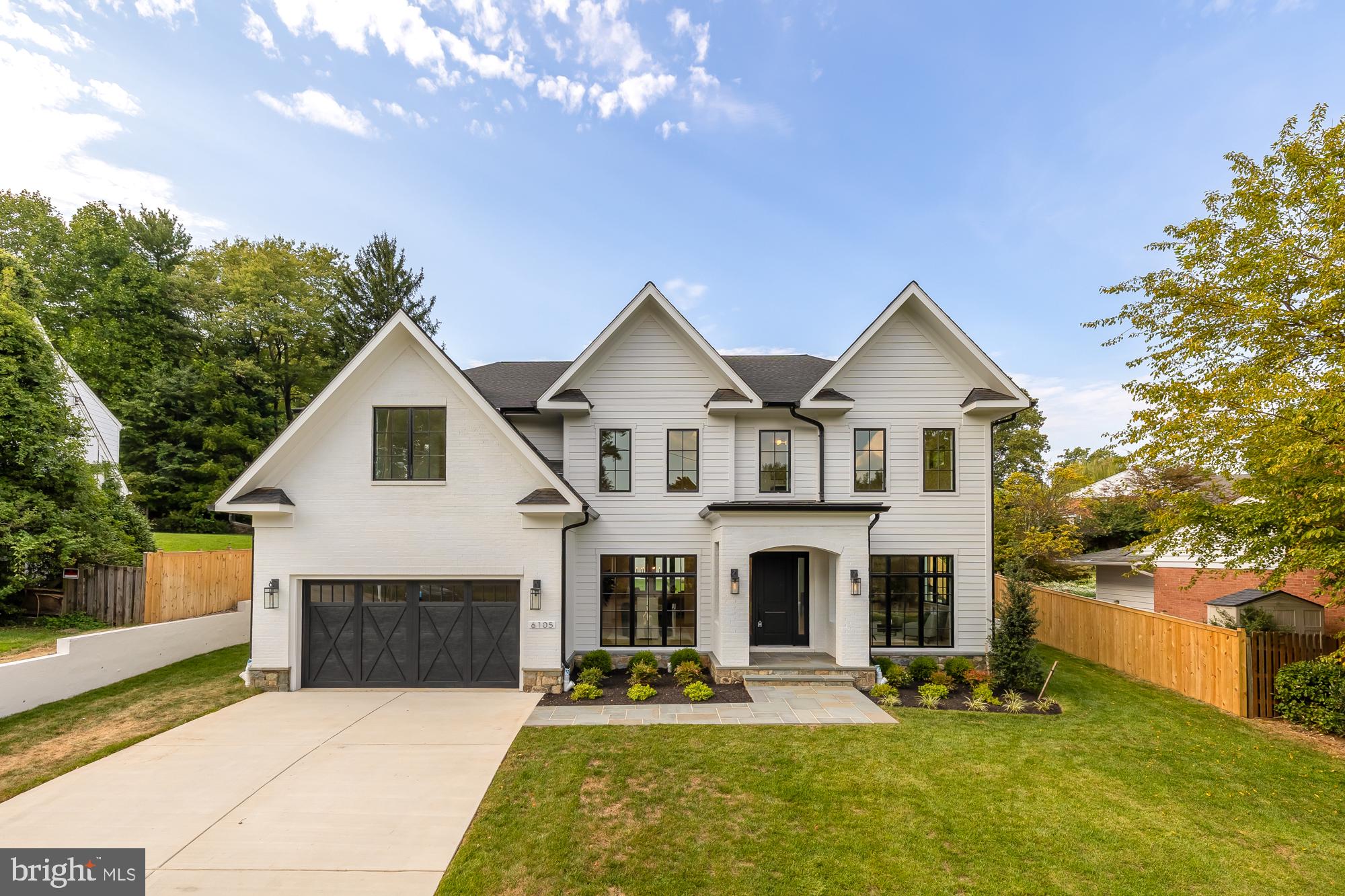 Location, location! Don’t miss seeing this spectacular property! Step into the elegance of 6105 Durbin Road, where sophistication meets contemporary design in Kenwood Park. This exceptional home built by Francis Development unveils a realm of distinctive features, offering a modern twist on Georgian architecture. This residence boasts 6 bedrooms and 6.5 baths across three impeccably finished levels, spanning nearly 7,000 sqft on a huge 15,000+ sqft lot! The white brick façade, adorned with a stylish portico, sets a tone of refined charm.

The main level boasts 10-foot ceilings, floor-to-ceiling Pella windows, and 7-inch white oak wide plank floors. Explore the spacious living and dining rooms on either side of the welcoming foyer. The great room boasts a gorgeous fireplace, ample windows, and glass doors leading to the patio sprawling backyard and covered patio, complete with a built-in fireplace—an ideal setting for year-round relaxation, grilling, or entertaining. The kitchen is a culinary haven, featuring quartz countertops, floor-to-ceiling cabinetry, and top-of-the-line appliances, including a 6-burner gas stove with double ovens. The center island provides ample eat-in space, seamlessly flowing into a large and sunlit breakfast area with access to the covered porch. A versatile den/home office with a closet and full bath, situated off the great room, can also serve as the 6th bedroom.

Ascend to the upper level, where luxury continues with 4 bedroom suites each with their own en-suite baths. The primary suite impresses with large windows, dual walk-in closets, and a spa-inspired bath featuring marble tile, a freestanding soaking tub, shower, and double vanities. The laundry room features a full window, built-in cabinets, a generous counter with a sink, and designer tiled flooring. Entertainment extends to the lower level with a vast recreation room with a wet bar, a game room, a home gym, and a versatile 5th bedroom with a walk-in closet and a window, complemented by a full bath with a tub/shower combo.

Francis Development's commitment to energy efficiency and contemporary upgrades shines through in this smart and highly efficient residence. Located in one of Bethesda's most sought-after neighborhoods, Kenwood Park, this home is just minutes away from Downtown Bethesda, where you can explore over 250 dining and shopping options, and it's also conveniently close to Washington, DC. Explore the allure of 6105 Durbin Road if you have a penchant for open floor plans, luxurious finishes, and a refreshing approach to modern living in the Bethesda area. Don't let this opportunity pass you by!