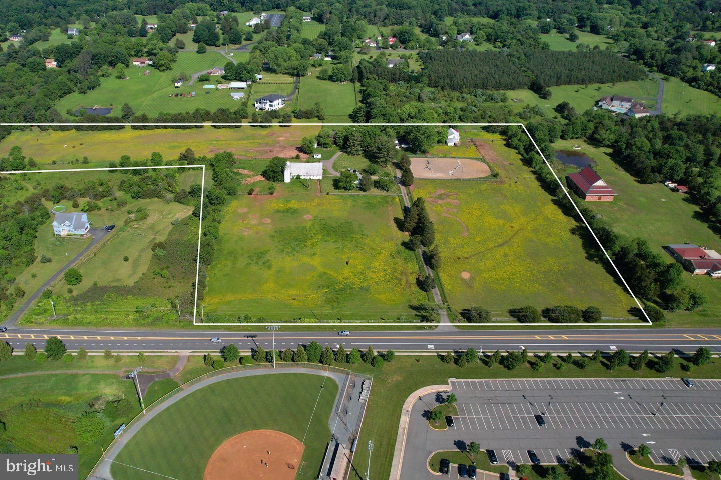 Location, location! Presenting a rare opportunity to own 20 beautiful acres of mostly cleared land, featuring two homes and two barns. Zoned A-1 with agritourism and multiple potential uses (some subject to special permits). Ideally located near major roads, parks, and shopping centers. Property is sold as-is.