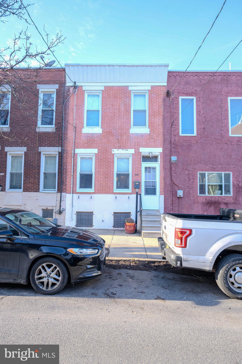 2610 Tulip Street is a beautiful two-story row home located on a peaceful block in the Fishtown/Old Richmond section of the city. This comfortable and cozy home features a combination of modern updates with the original character and charm of the area.  Charm can be seen immediately upon entering as you are greeted by the original, wide-plank, wood floors as well as the original restored slate fireplace. The combined living/dining room of the home is wide and bright with plenty of windows that allow natural light to flood the space. The living area flows directly into the kitchen which features a large breakfast bar, granite countertops, tile backsplash and stainless steel appliances. Off the kitchen in the rear of the home, is a large laundry room, a powder room and access to a small, fenced outdoor space. Up on the second floor you will find 3 bedrooms as well as a full bathroom. The front bedroom is the largest and features tall windows and a nicely sized closet. The other two bedrooms provide the perfect setting for a guest bedroom, a home office space or even a nursery! The basement of the home is partially finished and provides a great opportunity for storage or additional living space. The location of this home is perhaps what makes it most desirable as it is walkable to several neighborhood gems like Cook & Shaker, Circle and Squares Pizza and Meeting House! Also nearby, you will find amenities such as the shops at Fishtown Crossing and the popular restaurants and stores of Fishtown’s famous Frankford Ave!  If this sounds like a place you might want to call home, schedule a showing today!