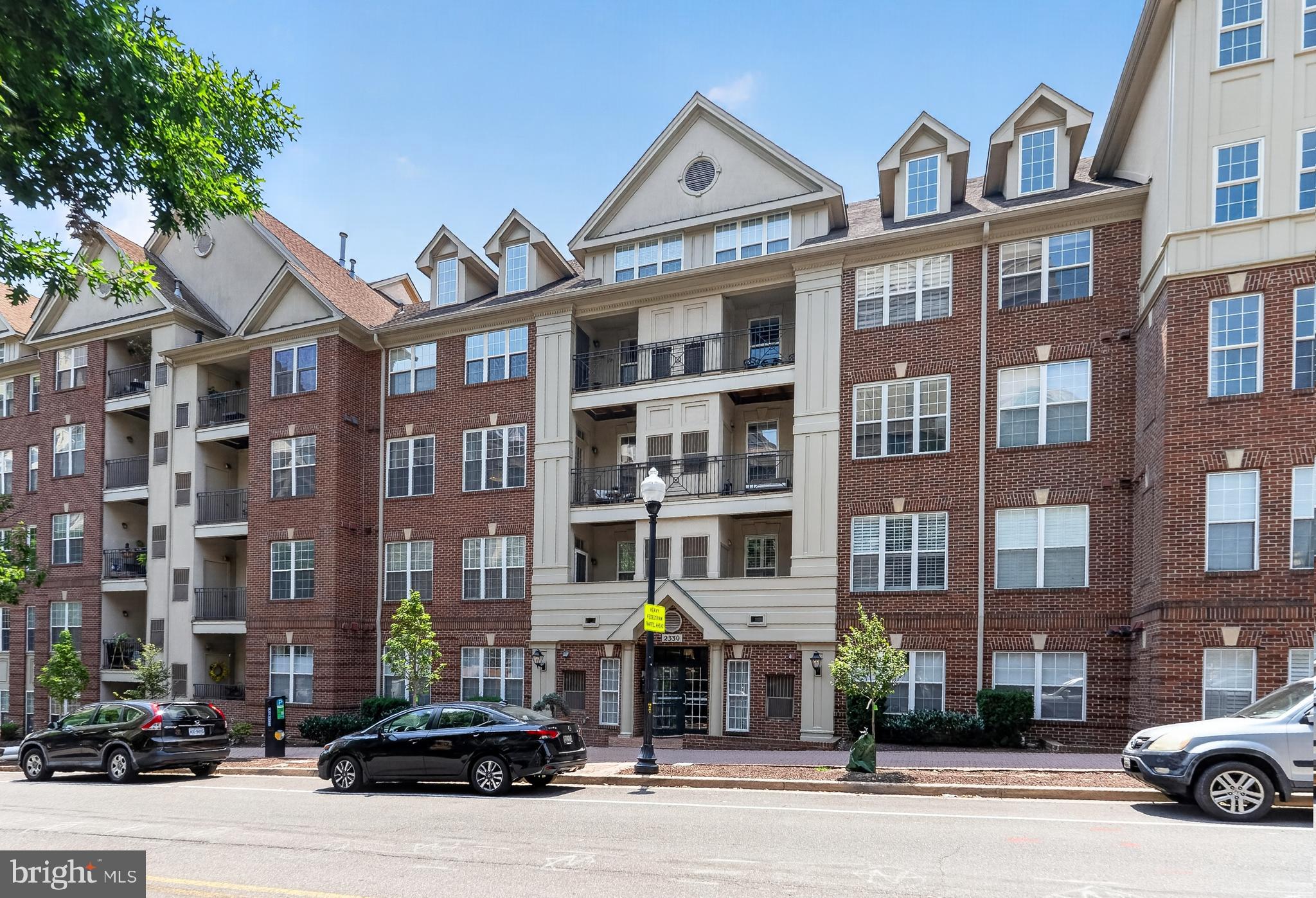 Rarely Available Penthouse Corner Residence in Courthouse Hill. Welcome to this exceptional two-level penthouse in the highly sought-after Courthouse Hill community. This light-filled, 3-bedroom, 2.5-bath corner residence offers an ideal combination of space, style, and an unbeatable Arlington location just moments from the Courthouse Metro. The open-concept main level is highlighted by soaring cathedral ceilings, oversized windows, and spacious living and dining areas centered around a cozy gas fireplace. A wraparound balcony extends the living space outdoors, providing the perfect spot to enjoy your morning coffee or unwind in the evening. The updated gourmet kitchen is designed for both everyday living and entertaining, featuring granite countertops, stainless steel appliances, abundant cabinetry, and a generous pantry. Rich hardwood flooring, including Brazilian cherry, walnut, and bamboo, adds warmth and character throughout the home, while fresh paint and updated lighting create a bright, modern feel.The flexible floor plan includes a spacious en-suite bedroom and an additional bedroom that can easily serve as a home office, along with another half bath on the main level. Upstairs, the private primary suite offers a peaceful retreat with two large walk-in closets and a spa-inspired bath featuring dual vanities, a soaking tub, and a separate glass-enclosed shower. Additional conveniences include two prime, secure garage parking spaces and in-unit laundry, offering comfort and functionality in one of North Arlington's most desirable communities. Courthouse Hill residents enjoy exceptional amenities, including a community pool, fitness center, clubhouse, and professional on-site management. Ideally situated in the heart of North Arlington, this home is less than a quarter mile from the Courthouse Metro and just steps from Whole Foods, Trader Joe's, restaurants, coffee shops, fitness studios, Rocky Run Park, the Arlington Farmers Market, and the vibrant Courthouse and Clarendon neighborhoods. With convenient access to Route 50, I-66, the George Washington Memorial Parkway, Washington, D.C., and Reagan National Airport, this residence offers the perfect blend of luxury, convenience, and walkable urban living.Don't miss this rare opportunity to own one of Courthouse Hill's most desirable penthouse residences. Photos & floor plans, Wednesday July 15th.