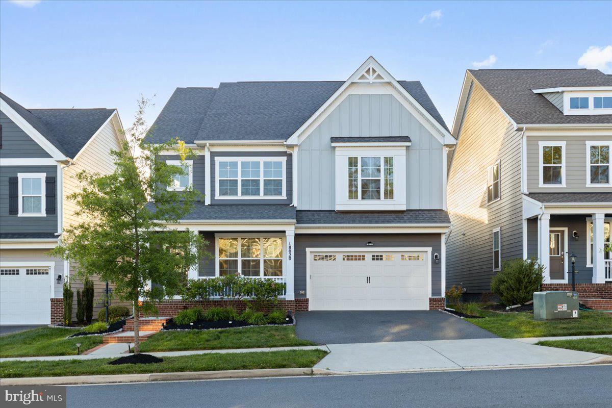 Welcome to 18020 Cedar Grove Lane — a beautifully appointed Beckner model located in the highly sought-after Potomac Shores community, where elevated living meets everyday comfort. Offering over 4,600 square feet, this residence combines spacious interiors, refined finishes, and the lifestyle today’s buyers are looking for. Featuring 4 bedrooms, 4 bathrooms, a 2-car garage, and a screened-in deck with retractable privacy shades, this home makes an impression from the moment you arrive! Step inside and you’re immediately greeted by light-filled spaces, luxury vinyl flooring throughout the main level, and elegant chair rail molding that adds a sophisticated touch throughout. The layout flows effortlessly, beginning with a versatile front living space ideal for a formal living room or dining room before opening into the true heart of the home. The rear living space seamlessly connects the grand room, dining room, and gourmet kitchen to create an open yet inviting atmosphere. The kitchen is both functional and beautifully designed, featuring granite countertops, an oversized island, gas cooktop with a statement hood, built-in wall oven and microwave, and abundant cabinetry that perfectly balances style and storage. Just beyond, the enclosed deck offers the perfect private escape for slow mornings, evening gatherings, or simply enjoying the comfort of home year-round. The main level also features a powder room, a bonus room ideal for a home office or play room, and a customized mudroom conveniently located off the garage entry. Upstairs, the spacious loft offers the perfect flex space for lounging, a reading nook, or a secondary living area. The primary suite feels like a true retreat, complete with a vestibule entry, dual walk-in closets, and a spa-inspired ensuite bath featuring separate vanities and a large walk-in shower. Three additional bedrooms, a full hallway bath, and an upper-level laundry room complete the upper level. The finished basement adds another layer of versatility to the home, beginning with a generously sized recreation area perfect for entertaining, relaxing, or everyday living. This level also features a full bathroom, custom barn doors that open to a secondary recreation space ideal for a media room, lounge area, or home gym, as well as an unfinished bonus room offering additional storage or future customization potential. Notable features of the home include a radon mitigation system, exterior sprinkler system, and the added peace of mind of a one-year home warranty included with the purchase! Beyond the home itself, Potomac Shores offers a lifestyle that is truly unmatched - residents enjoy access to resort-style pools, the Social Barn, Fitness Barn, Jack Nicklaus Signature Golf Course, Tidewater Grill restaurant, scenic walking/biking trails, basketball court, playgrounds, and peaceful views along the Potomac River. The HOA also includes high-speed internet and trash service, while easy access to I-95,  Quantico, and the future VRE station adds to the convenience of everyday commuting and travel.  Don’t miss the opportunity to purchase in one of the area’s most sought-after and steadily growing communities!! Schedule your tour today!