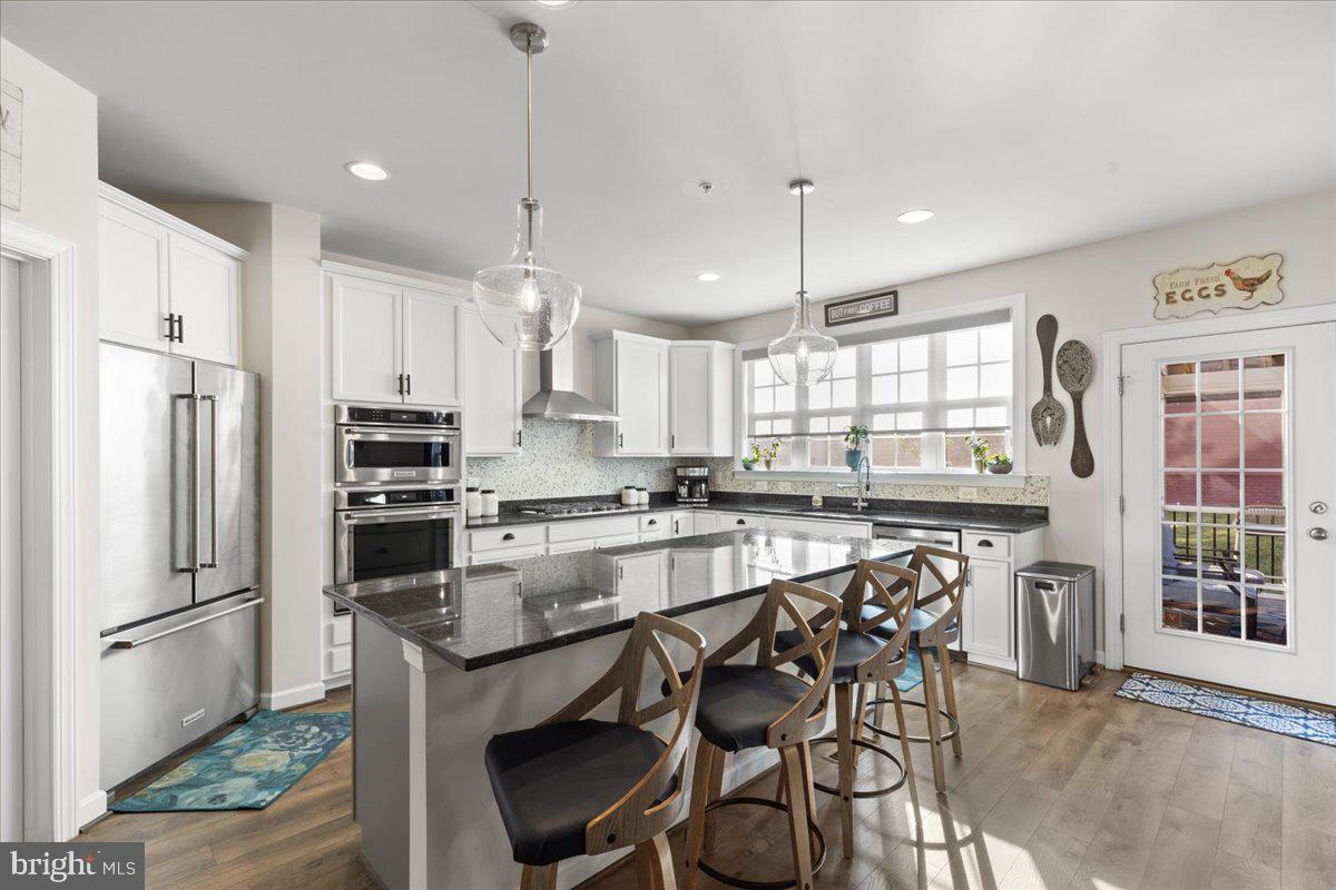 ***SELLERS ARE OFFERING CLOSING COSTS ASSISTANCE AND QUALIFIED BUYERS WILL RECEIVE A FREE 1% LENDER CREDIT WITH USE OF EMBRACE HOME LOANS!*** Welcome to 18020 Cedar Grove Lane — a beautifully appointed Beckner model located in the highly sought-after Potomac Shores community, where elevated living meets everyday comfort. Offering over 4,600 square feet, this residence combines spacious interiors, refined finishes, and the lifestyle today’s buyers are looking for. Featuring 4 bedrooms, 4 bathrooms, a 2-car garage, and a screened-in deck with retractable privacy shades, this home makes an impression from the moment you arrive! Step inside and you’re immediately greeted by light-filled spaces, luxury vinyl flooring throughout the main level, and elegant chair rail molding that adds a sophisticated touch throughout. The layout flows effortlessly, beginning with a versatile front living space ideal for a formal living room or dining room before opening into the true heart of the home. The rear living space seamlessly connects the grand room, dining room, and gourmet kitchen to create an open yet inviting atmosphere. The kitchen is both functional and beautifully designed, featuring granite countertops, an oversized island, gas cooktop with a statement hood, built-in wall oven and microwave, and abundant cabinetry that perfectly balances style and storage. Just beyond, the enclosed deck offers the perfect private escape for slow mornings, evening gatherings, or simply enjoying the comfort of home year-round. The main level also features a powder room, a bonus room ideal for a home office or play room, and a customized mudroom conveniently located off the garage entry. Upstairs, the spacious loft offers the perfect flex space for lounging, a reading nook, or a secondary living area. The primary suite feels like a true retreat, complete with a vestibule entry, dual walk-in closets, and a spa-inspired ensuite bath featuring separate vanities and a large walk-in shower. Three additional bedrooms, a full hallway bath, and an upper-level laundry room complete the upper level. The finished basement adds another layer of versatility to the home, beginning with a generously sized recreation area perfect for entertaining, relaxing, or everyday living. This level also features a full bathroom, custom barn doors that open to a secondary recreation space ideal for a media room, lounge area, or home gym, as well as an unfinished bonus room offering additional storage or future customization potential. Notable features of the home include a radon mitigation system, exterior sprinkler system, and the added peace of mind of a one-year home warranty included with the purchase! Beyond the home itself, Potomac Shores offers a lifestyle that is truly unmatched - residents enjoy access to resort-style pools, the Social Barn, Fitness Barn, Jack Nicklaus Signature Golf Course, Tidewater Grill restaurant, scenic walking/biking trails, basketball court, playgrounds, and peaceful views along the Potomac River. The HOA also includes high-speed internet and trash service, while easy access to I-95,  Quantico, and the future VRE station adds to the convenience of everyday commuting and travel.  Don’t miss the opportunity to purchase in one of the area’s most sought-after and steadily growing communities!! Schedule your tour today!