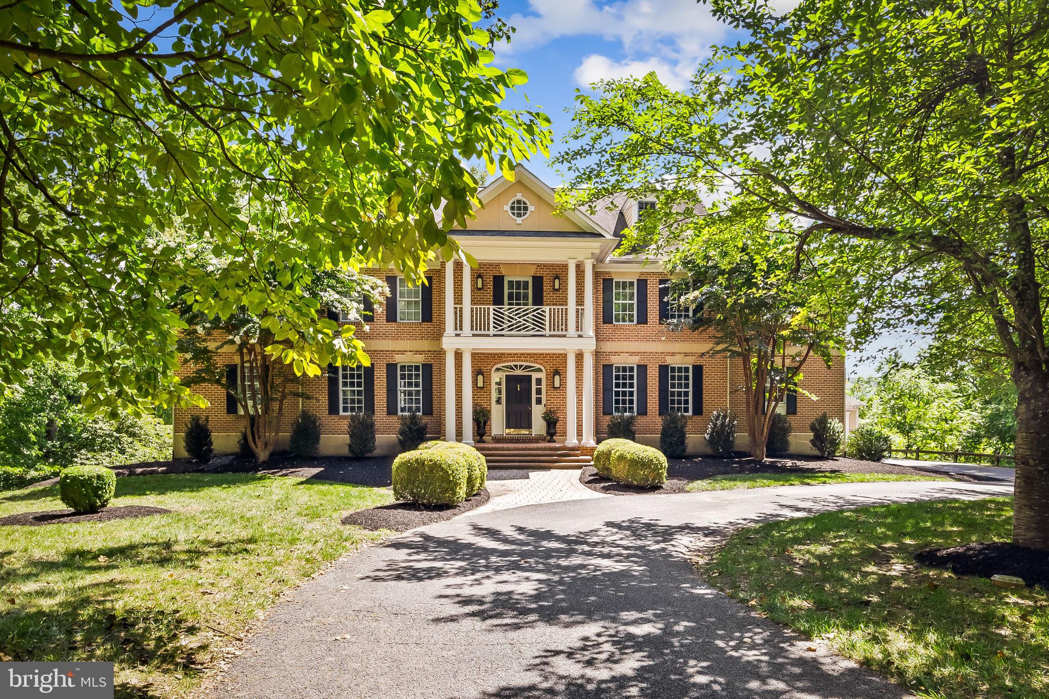 Tucked away adjacent to Eagle’s Nest Country Club, 12829 Stone Eagle Road is a splendid all-brick Colonial home in the Eagle’s Nest Estates community offering the perfect blend of suburban surroundings and urban accessibility. The home spans four finished levels and features seven bedrooms, five full baths, and two half baths.  The layout and space can accommodate various living arrangements. Step into the grand two-story foyer that opens to a bright, contemporary interior, adorned with detailed millwork, including wainscoting, crown molding, and built-in bookshelves. Hardwood flooring, recessed lighting, and soaring 9+ foot ceilings add to the home's elegance. Five fireplaces offer warmth and sophistication throughout. The main level boasts a formal dining room, living room, and a sizable family room that opens to an expansive rear deck. The gourmet kitchen is a chef’s dream, featuring high-end appliances, white shaker-style cabinetry, white quartz countertops, and white subway tile backsplash. The eat-in kitchen layout seamlessly flows into the versatile bonus space, ideal for a TV room, playroom, or study area. Additional highlights on this level include a private office, a large sunroom, and two half-baths. Ascend to the second-level hall, where a wraparound banister overlooks the grand foyer. The primary suite is a true retreat with a cozy fireplace, a separate sitting room, two dressing rooms, and a luxury bath. Three bedrooms, two full baths, and a convenient laundry room finish this level.  Providing comfort and space, two more bedrooms and a full bath are located on the top level. The walk-out lower level is complete with entertainment options, including a recreation room with a fireplace, a media room, and a fitness room equipped with rubber gym flooring. The home’s seventh bedroom and a full bath make hosting overnight guests a breeze. Enjoy elevated views from the rear deck and notice the peaceful atmosphere the mature trees generate around the home. The attached garage and a separate detached garage accommodate four cars and offer additional storage space. With its prime location in Baltimore County, the community is a short drive to shopping centers, restaurants, entertainment, and commuter routes. Minutes away from Loch Raven Reservoir, outdoor enthusiasts will appreciate hiking, rowing, paddle boating, bird watching, horseback riding, hunting, and fishing. Schedule your visit today to view this home with desirable features inside and out.