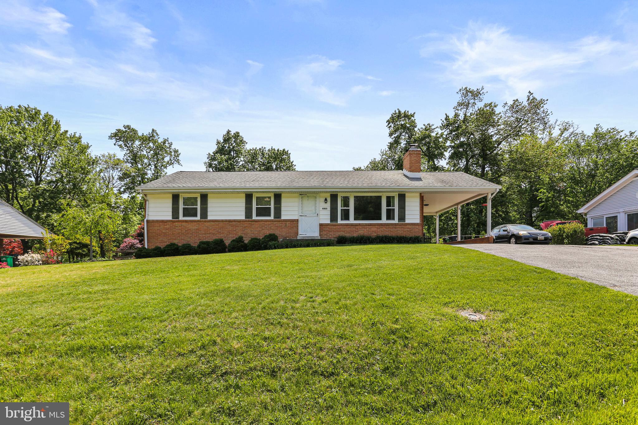 Welcome to this lovely classic rancher in the quiet community of Rocky Gorge Estates in West Laurel. This home has an amazing backyard and features many upgrades. The home is situated on a breathtaking flat .53-acre lot with a fully fenced back yard surrounded by mature trees. The notable upgrades include a brand-new HVAC system (installed in April 2025), replacement roof, replacement windows, renovated kitchen and bathrooms! The home consists of a spacious, updated kitchen boasting beautiful maple shaker cabinets, granite countertops, stainless-steel appliances and white subway tile backsplash. A generous size dining room offers a bay window with a wonderful view of the back yard.  The living room includes a wood burning insert flanked by custom built-in shelves and a large picture window allowing ample natural light.  Gleaming natural hardwood floors are displayed throughout the main level.  The primary bedroom includes a large closet, a ceiling fan, an en-suite bathroom with white subway tile accented by a sleek tile border, clear glass shower doors, updated vanity and more!  Two additional generous size bedrooms with ceiling fans and an updated guest bathroom complete the main level of the home.  Plenty of storage and space (approximately 1300+ sq ft) can be found in the bright walk-up unfinished basement.  The basement's door is newly replaced and the basement windows are also replacement windows.  This basement is awaiting your finishing touches.  The exterior of the home offers a covered carport with ample parking on the paved driveway and a newer large storage shed complete with electric within the spectacular, fully fenced back yard.  This home has been lovingly cared for and is completely move-in ready! **Please view 360 Photo Tour**