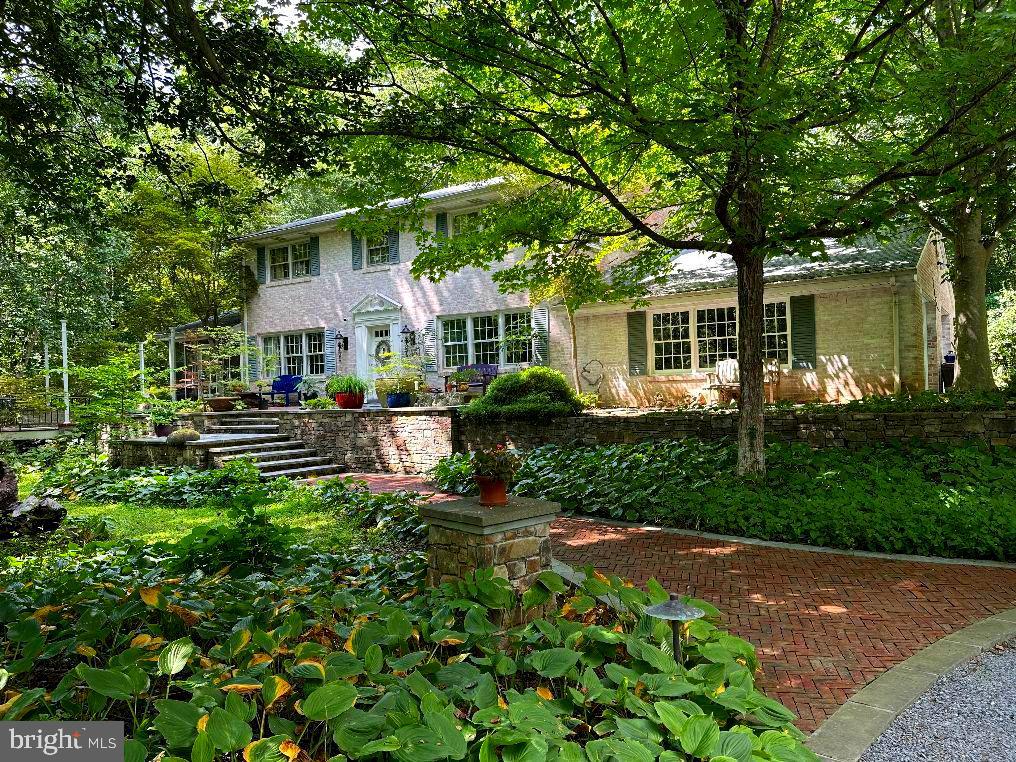 An amazing opportunity to own in the highly sought-after community of Highland, MD. This property showcases a lifetime of artistic architecture and engineered landscaping. A labor of love—a love for natural habitats and a passion for the elements of nature—has transformed this space into a serene oasis. The exotic plantings of shrubs, trees, and ground coverings throughout the property make it a true one-of-a-kind.
It’s unique, with exquisite views and enchanting driveway-width trails that lead to Serenity Pond. There are multiple sitting areas that offer private, meditative sanctuaries, surrounded only by the sounds of nature: birds chirping, water rippling in the brook. This is a real treasure, featuring authentic stone retaining walls, stone bridge backwalls, two natural spring-fed ponds, and a cleared plateau (80' x 30') pre-leveled for a potential future build.
The first building you'll see on the left as you approach the home is a separate 2,500 sq. ft. gallery/studio. with extra large wood burning fireplace, Antique Safe in the Office,is to convey w/property, all on the main level, Lower Level, includes an industrial-grade workshop in the lower level with 3-phase electrical supply, and a wood burning stove. This building features extra-large, strapped-hinge rough-sawn oak doors on both levels to accommodate large sculptures or other oversized pieces. The gallery, as we call it, was over-engineered for live load and large-scale artwork. It would also be ideal for yoga, dance, or workout classes—its uses are only limited by your imagination.
Continue up the gravel driveway to the circular drive and you'll find a luxurious red brick herringbone walkway leading to the main house and two patios. To the right is a flagstone sitting area; to the left, an oversized octagonal patio constructed with exotic wood decking and steel columns. Magnificent for night entertainment, w/Mardigra  Lights, Party Ready. This patio now awaits your personal touch. It features a built-in center firepit, Gourmet Grill, and overlooks Serenity Pond, and is adjacent to the large screened in Porch.
Finally, the house itself: a spaciously designed floor plan with 5 bedrooms, 3.5 baths, 3 wood-burning fireplaces, a fully finished walk-out basement, and a 2-car garage directly off the kitchen—perfect for unloading groceries during inclement weather. The home is bathed in natural light throughout.

There is so much more to see. Touring this extraordinary property and experiencing its serene mystique will make it hard for you to leave.

Please Note: All showings require 24-hour notice. The listing agent or owner will be present. No walk-ups. Please respect the owner's privacy—without an appointment, you will be considered trespassing. Be sure to click on icon in top ledger of the listing for virtual tours videos, Video Tittle, "It's A Different Kind of Peace", Thanks