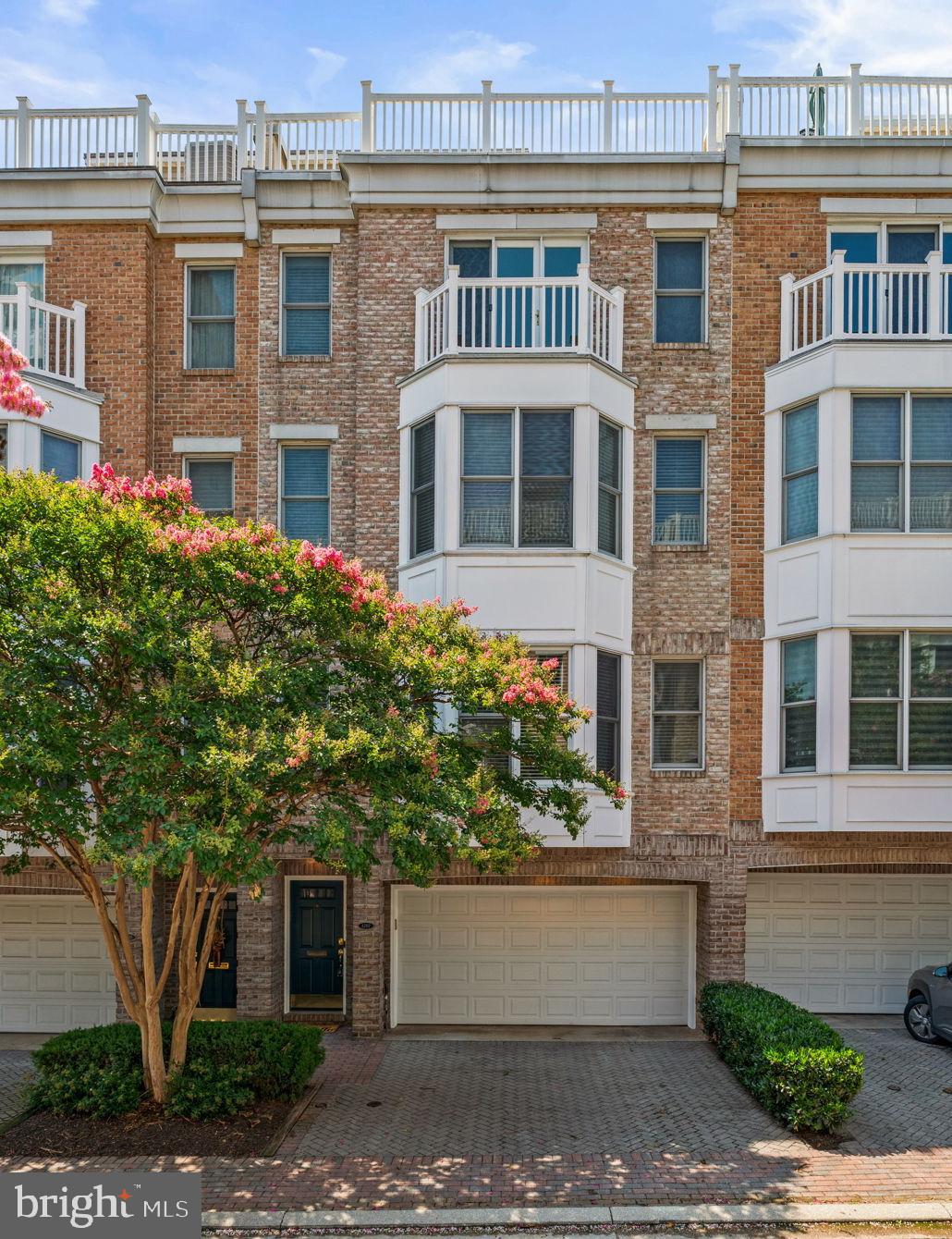 Welcome to 1207 Harbor Island Walk, an exceptional luxury townhome in the prestigious WATERFRONT COMMUNITY of HarborView. Perfectly blending elegant finishes, sophisticated design, and breathtaking views, this spacious residence offers multiple levels of thoughtfully designed living, an elevator serving all levels of the home, and spectacular outdoor spaces overlooking the Inner Harbor.    Step inside to a welcoming foyer where you'll immediately appreciate the quality craftsmanship found throughout.  Here you will find additional living space with a generously sized bedroom featuring brand-new carpet, an attached full bath, and direct access to a peaceful brick patio overlooking the tranquil community pond. This level also offers interior access to the oversized two-car garage, complete with an EV charging station and additional storage space.  From all levels, you are able to access the fully functional ELEVATOR, creating true ease of living in this gorgeous home!  On the next level up, the beautifully refinished hardwood floors are found throughout. Also featured are soaring ceilings, recessed lighting, and a seamless open floor plan designed for both everyday living and entertaining, alike. The gourmet kitchen is the heart of the home, showcasing granite countertops, a custom tile backsplash, a large center island, stainless appliances, a five-burner cooktop, double wall ovens, a pantry, and a spacious breakfast area. Just off the kitchen, enjoy your morning coffee or evenings unwinding on one of many private balconies. The formal dining area features custom built-in bench seating and shelving, while the spacious living room is highlighted by a cozy gas fireplace. A conveniently located powder room completes this level.    On the 2nd level up, the primary suite is created as a true owner's retreat. The spacious bedroom features hardwood flooring, recessed lighting, a ceiling fan, and elegant window treatments. A large walk-through closet leads to the luxurious ensuite bath with a dual-sink vanity, a soaking tub, and separate walk-in shower. Also on this level is a dedicated home office complete with custom built-in desk and shelving, making working from home both comfortable and convenient.    The third level up offers incredible flexibility with a spacious family room featuring custom built-ins and generous closet space, along with an additional bedroom that opens to its own private balcony. This level also includes a full bath, laundry, crown molding, and comfortable carpeting throughout.    The uppermost level is truly the crown jewel of the home. A stylish entertaining area with tile flooring, a wet bar, wine refrigerator, and skylight opens directly to the spectacular rooftop deck. Here you'll enjoy panoramic views of Baltimore's Inner Harbor, creating an unforgettable setting for entertaining guests, dining under the stars, or simply relaxing while taking in the city skyline.    ****    Additional features include a fully operational elevator servicing all levels, two-zone HVAC with dual furnaces, a central vacuum system, an in-home sprinkler system, wall and ceiling-mounted speaker system throughout, and a gas fireplace.    ****    Located within the exclusive HarborView community, residents enjoy resort-style amenities including 24-hour gated security, outdoor pool, fitness center, marina access, walking paths, beautifully maintained grounds, and easy access to the Baltimore Waterfront Promenade. Just moments from Federal Hill, the Inner Harbor, Cross Street Market, Camden Yards, M&T Bank Stadium, Riverside Park, and countless award-winning restaurants, shops, and entertainment venues, this remarkable home offers luxury waterfront living with unparalleled convenience to I-95, I-395, BWI Airport, and downtown Baltimore.