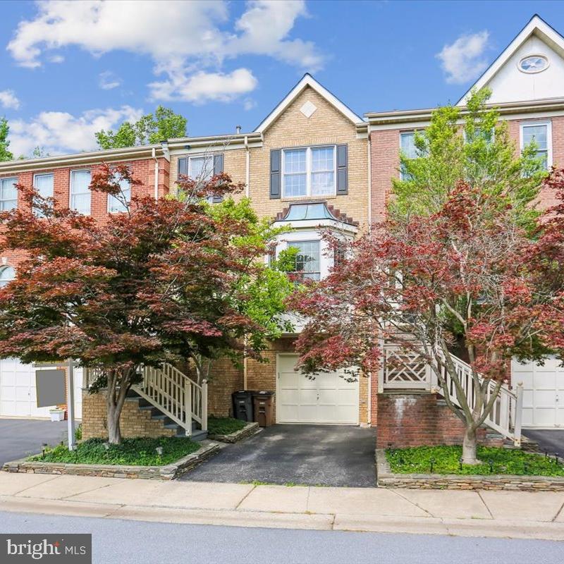 Beautiful brick townhouse in highly sought after Rose Hill Falls. With Total SQFT 2, 664 of living area on three levels. Special features include 9-foot, cathedral. and vaulted ceilings, maple hardwood flooring, upgraded lighting, custom molding and newer quartz countertops and kitchen cabinetry. Beautiful outdoor deck, stone patio and yard overlooking trees and common area. Entertain your guests in the formal living room and dining room combo with floor-to-ceiling windows or in the open kitchen family room floorplan.  The kitchen is complete with newer quartz countertops and cabinetry with under-mount lighting, a center island/break first bar with a gas downdraft cooktop, large pantry, a breakfast nook and glass  door leading to the large rear deck. The family room off the kitchen has a floor to ceiling stone fireplace, a wet bar and an abundance of natural light. The primary bedroom suite features cathedral ceiling, a sitting area, a walk-in closet, jacuzzi whirlpool, and a walking shower. Two additional bedrooms with vaulted ceilings and double -doors closets. The lower-level recreation room walks out to the large stone patio and overlooks the wooded common area. There is full bathroom and garage access located on the lower level. HVAC was installed in 2019. There are over a mile of bucolic walking/bike paths, forested conservation areas, sidewalks, a private tennis court, and basketball court. New owner s will be part of the vibrant Rockville Town Center featuring shopping, restaurants, cafes, the Rockville Regional Library, Movie Theater, and other entertainments. Less than a mile from Interstate 1-270, Rockville Metro Station, other and public transportation. Hurry, this won't last!! A new wall oven will be installed before the closing. Open House on June 20, 26 from 12-3pm, and June 2126 from 1-4pm.