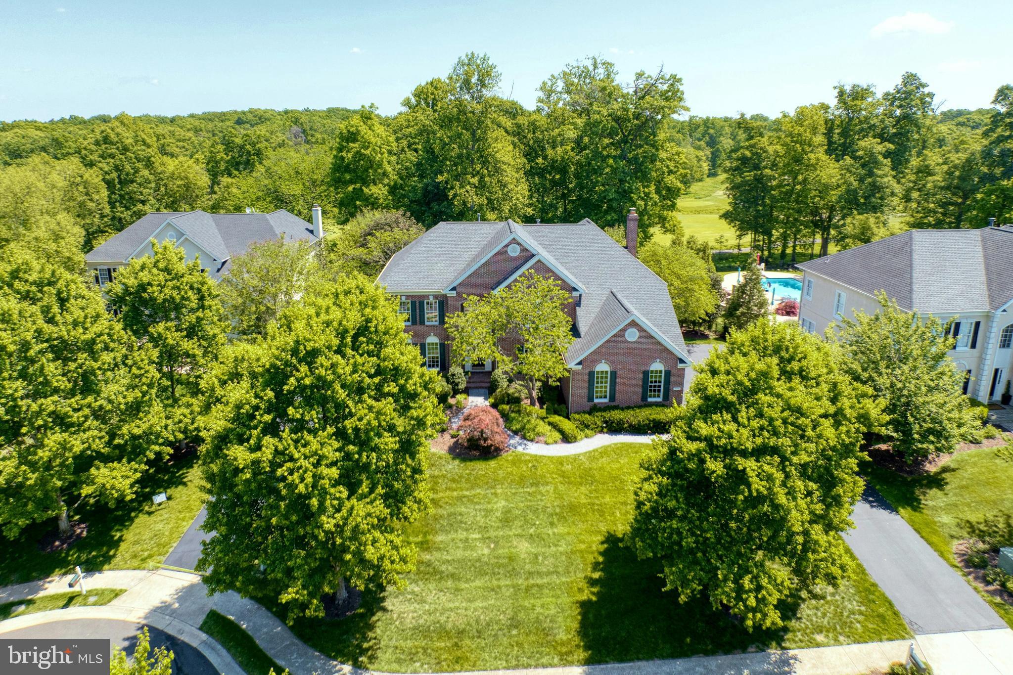 Welcome home to this stunning brick front Toll Brothers built home on a private .48 acre lot on a cul-de-sac street in the highly coveted gated Belmont Country Club golf course community of Ashburn. This beautiful home features 4 bedrooms, 4.5 baths, over 5600 square feet of indoor living space, fresh paint throughout much of the home & an incredible rear yard with trees backing to the golf course. Inviting two story foyer with curved staircase & detailed molding welcomes you as you enter this home. Spacious living room & formal dining room with detailed moldings & custom lighting. The gourmet kitchen was renovated in 2020 & features stainless steel appliances, upgraded quartzite countertops, tons of cabinet space, center island, pantry & spacious eating area. The grand two story family room features a wall of windows providing tons of light, new carpet (2026), cozy wood burning fireplace & rear staircase. Private main level office with built-ins provides ideal work from home space. The main level also features a powder room & mudroom leading out to the oversized 3-car garage. Spacious primary suite features a luxurious renovated full bath & two walk-in closets. The secondary bedrooms all feature new carpet (2026) & includes bedrooms two and three with a shared updated bath as well as a fourth bedroom with private full bath. The finished lower level is an entertainer’s dream with multiple areas including a recreation room, pool table area, exercise area, custom bar with refrigerators, 4th full bath, media room & storage! The outdoor living space includes an incredible covered porch & deck overlooking the picturesque rear yard with trees & views of the golf course. This home has been meticulously  maintained by the original owners whom have updated the roof, water heater & upper level HVAC. The monthly HOA Fee includes lawn mowing, high speed internet, cable TV, trash removal, community swimming pool, playground & more. Belmont Country Club offers many social events & golf course memberships are available! This home is conveniently located nearly local dining, shopping, entertainment & commuter routes.